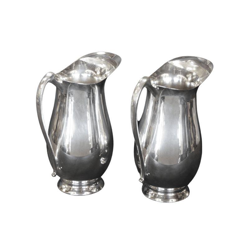Pair of silver pitchers in the style of Georg Jensen.