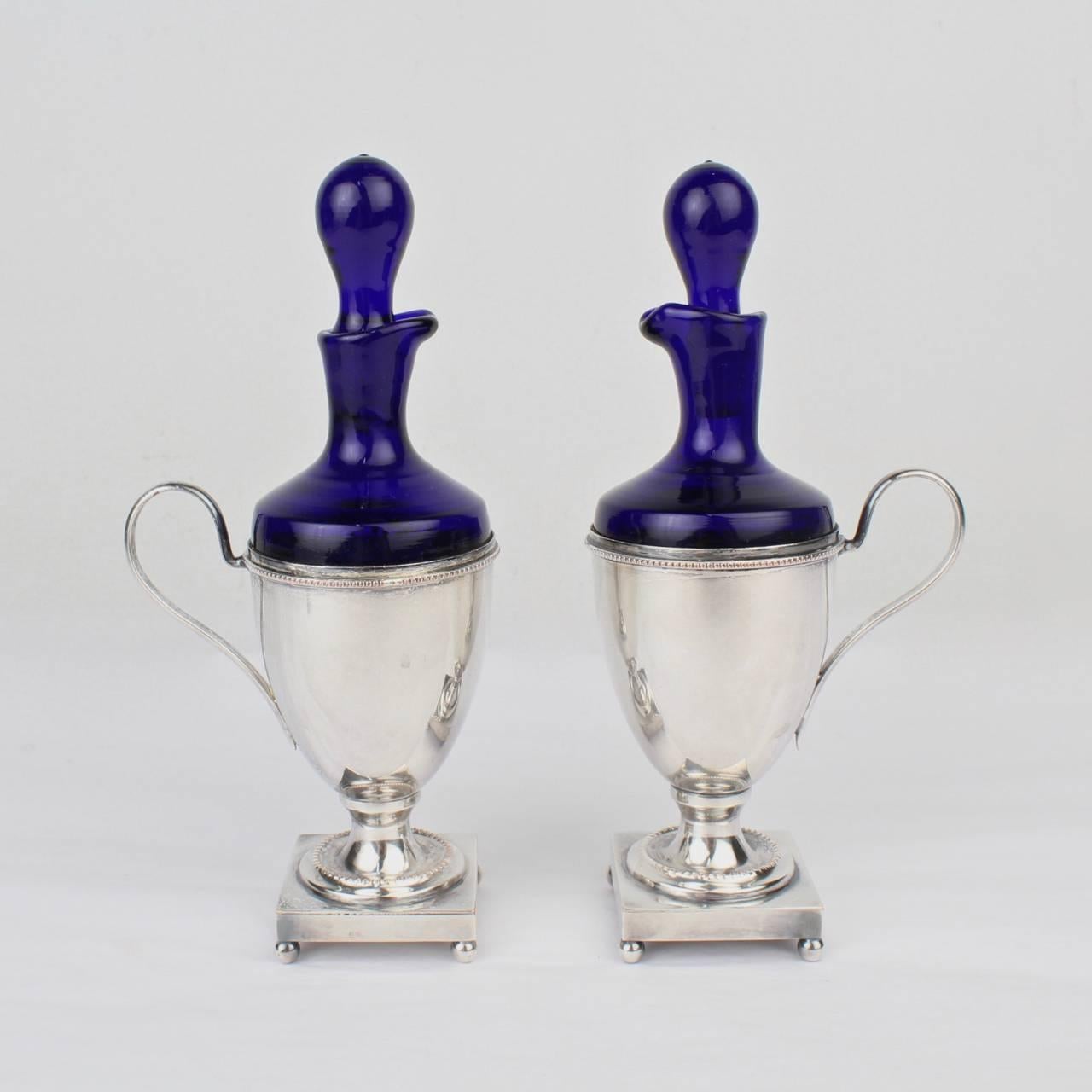 A fine matched pair of oil and vinegar cruets in by Israel Freeman.

Consisting of silver plate (on copper) bases and cobalt blue glass bottles and stoppers.

Bases marked for Israel Freeman of New York.

Height: ca. 6 3/4 inches.





 