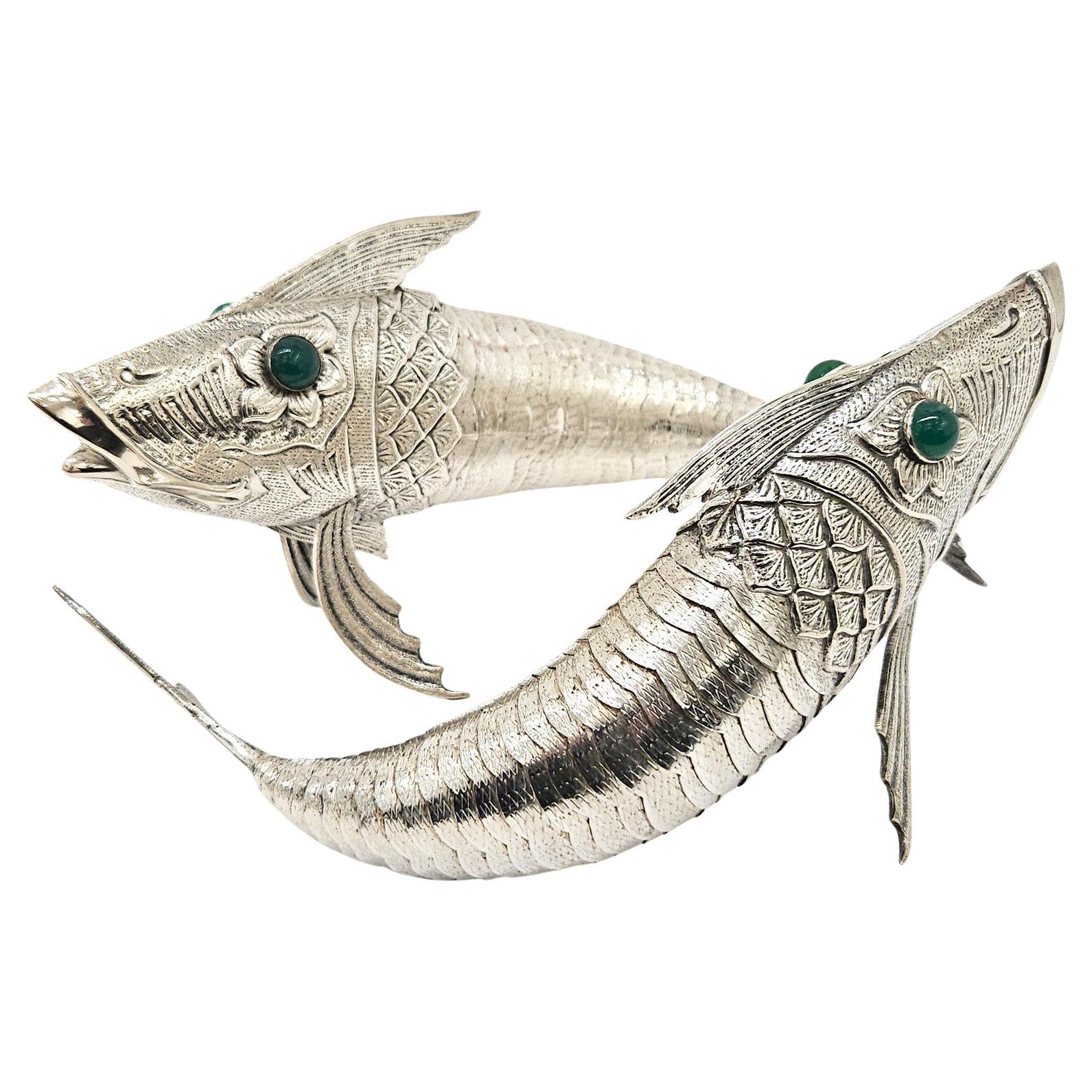 A wonderful pair of silver plate articulated fish ornaments made in Spain, c. 1920. They are of satisfying size and are highly decorative as a pair.

The tails of these fish are articulated so that they have an elegant slinky movement to them –