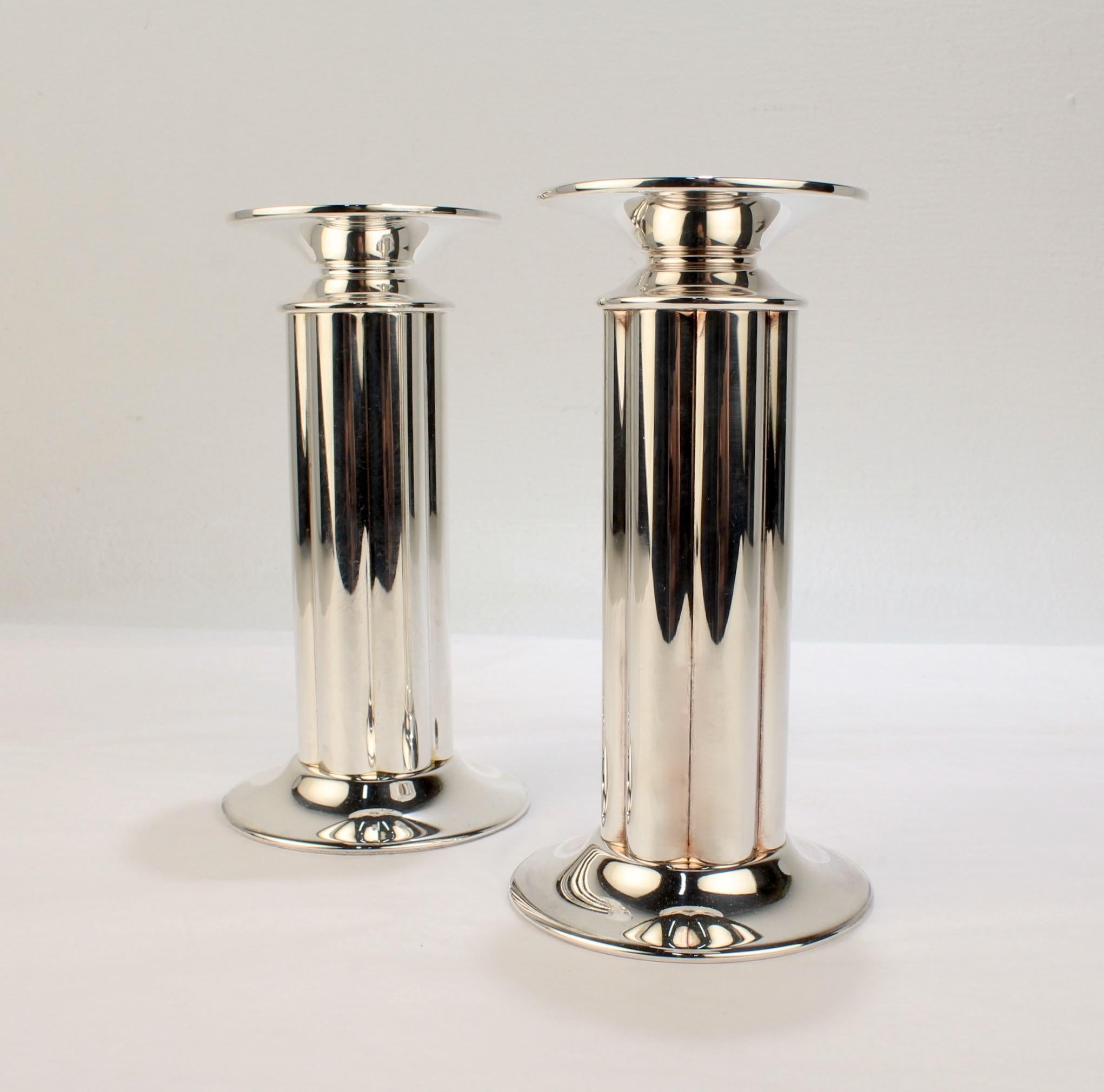 A fine pair of postmodern silver-plated candlesticks.

Designed by Robert A. M. Stern for Swid Powell.

In the form of stout, fluted columns with broad flat bobeches. 

Swid Powell was the highly acclaimed New York City based tableware company