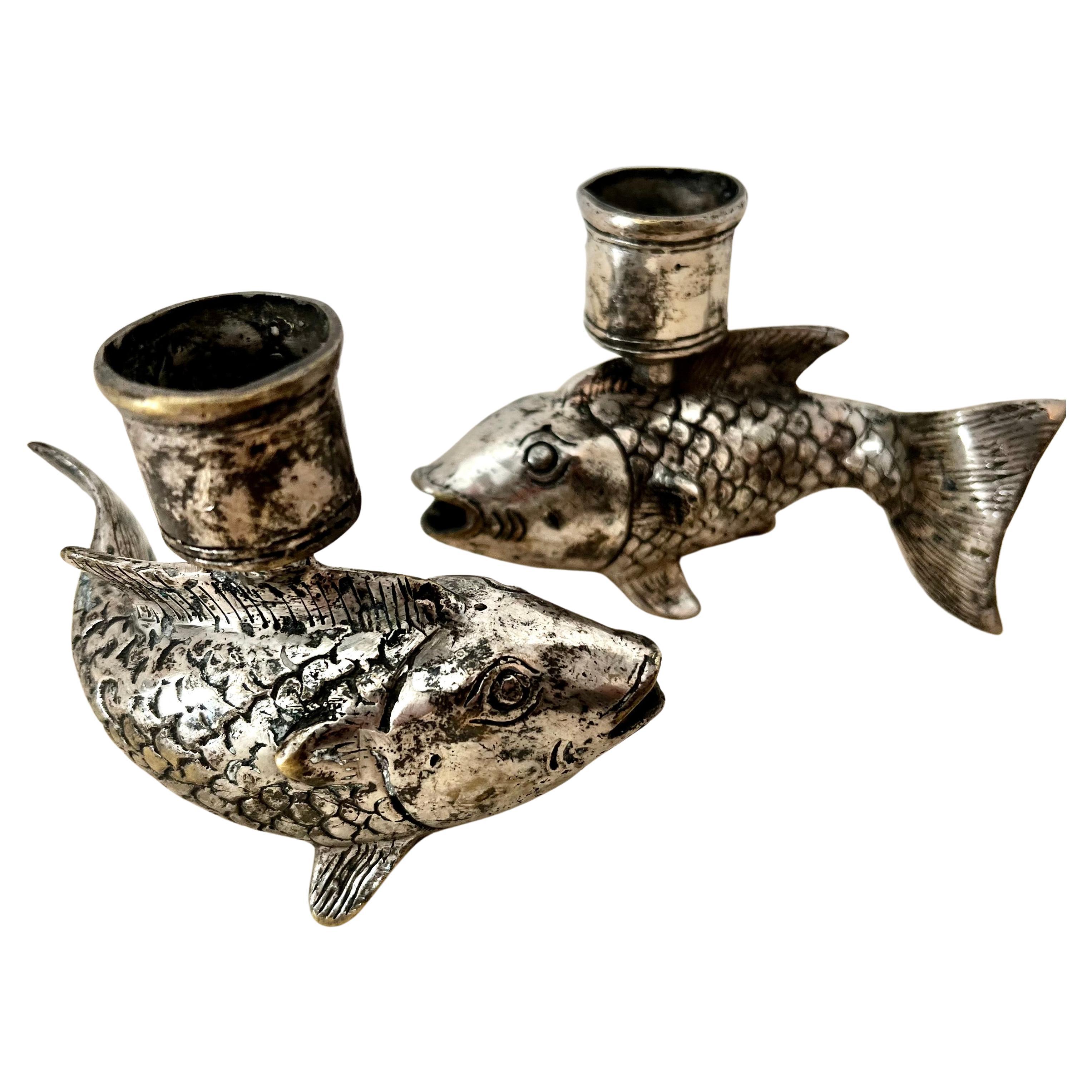 Pair of silver plate over brass candlesticks. A lovely pair of koi fish in a beautifully shaped design. The pair are low and wouldn't obstruct a casual to romantic dinner... or would be a compliment to a side, console or entry table with stack of