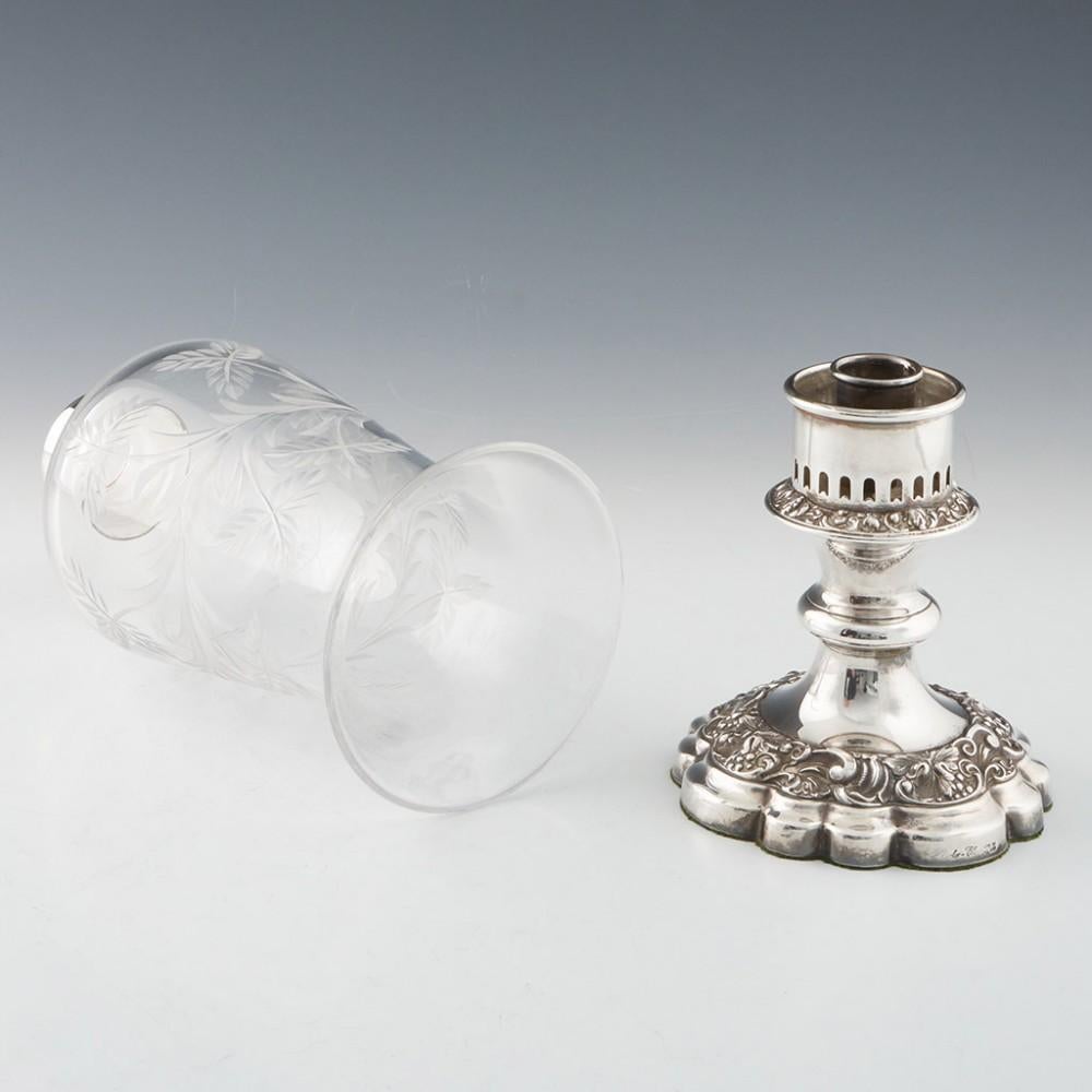 Heading : Pair of silver plated and glass Barker-Ellis candlesticks 
Date : c1965
Period : Elizabeth II
Origin : Birmingham England
Decoration : The glass chimney engraved with a foliate design, the csalloped bases with fruiting vines
Size :  Height