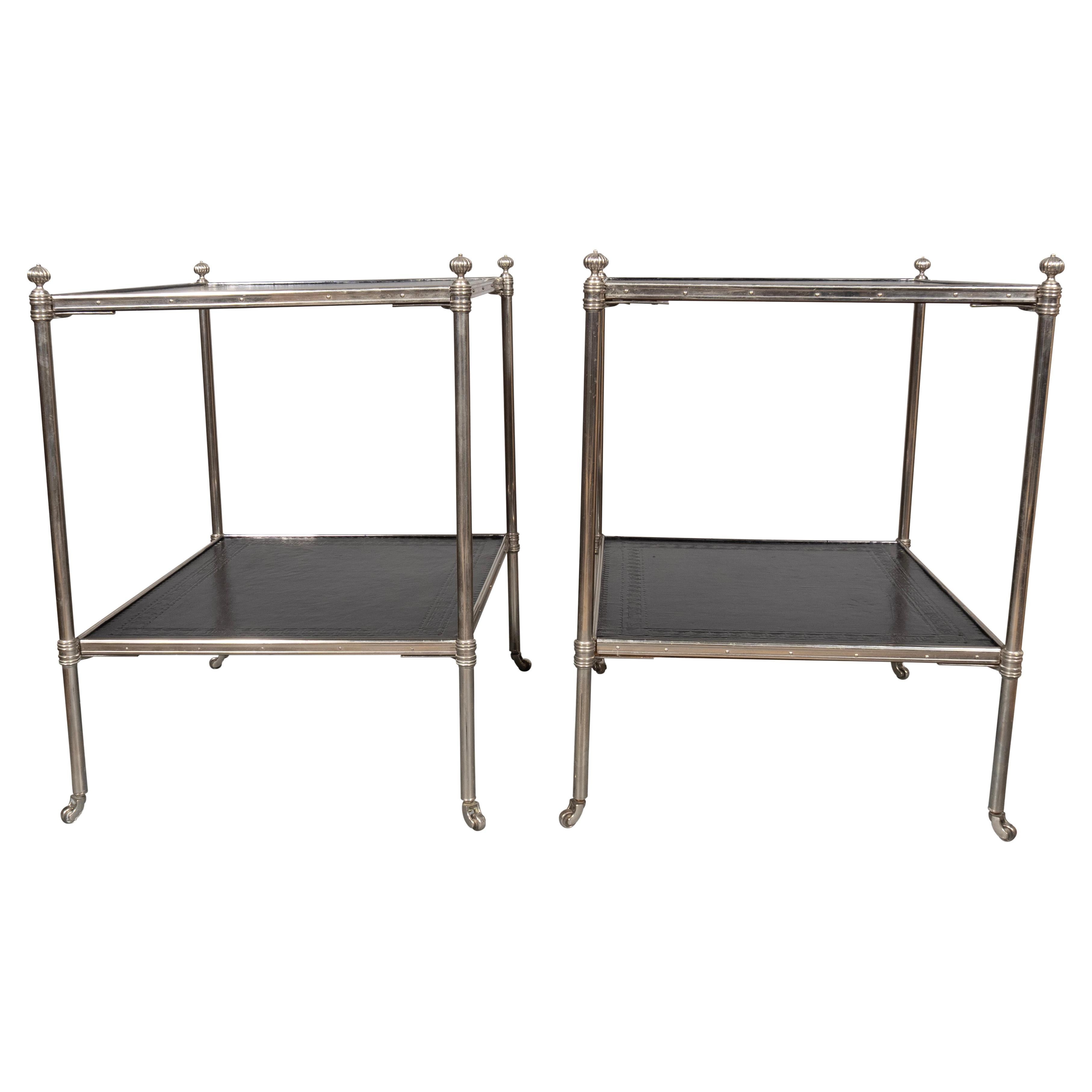 Square two tier with ball finials. Dark green almost black leather shelves. Tubular frames each with casters.