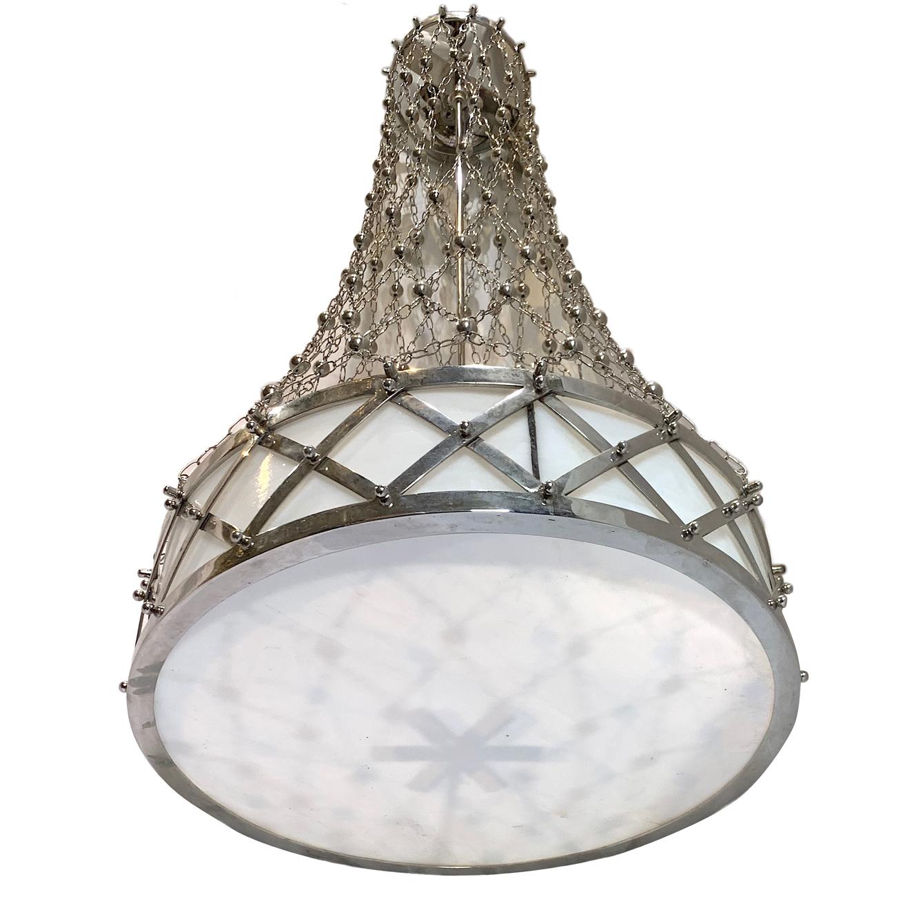 Pair of circa 1920’s French silver-plated light fixtures with net chain and milk glass insets with three interior Edison sockets. Sold individually.

Measurements:
Diameter: 18?
Drop: 40? (adjustable).