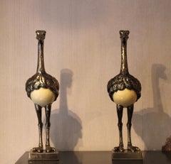 Pair of silver-plated blue-eyed ostriches with egg, 20th century