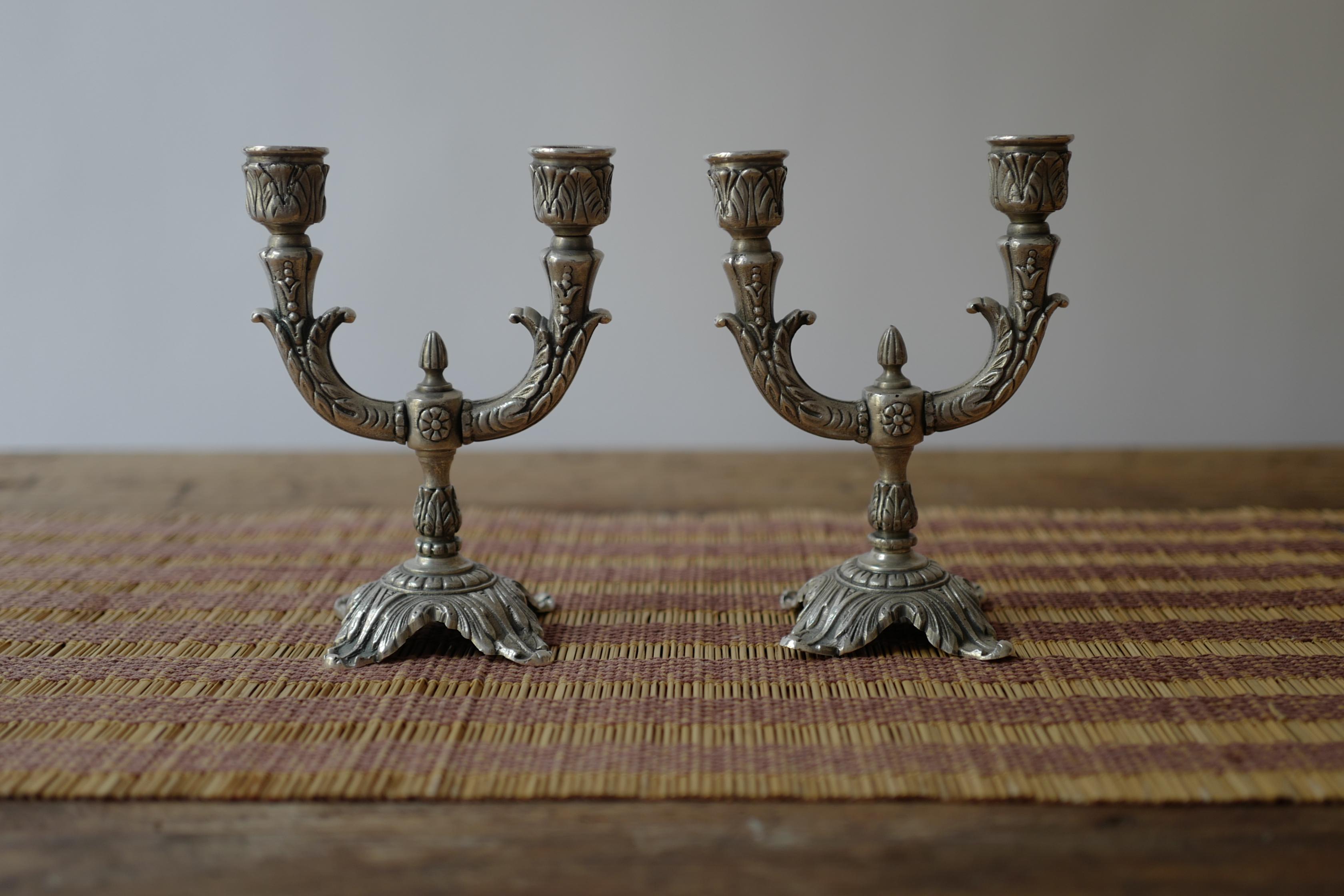 Pair of silver plated bronze french candlesticks with beautiful hand crafted decorative detail. Circa 19th Century. 