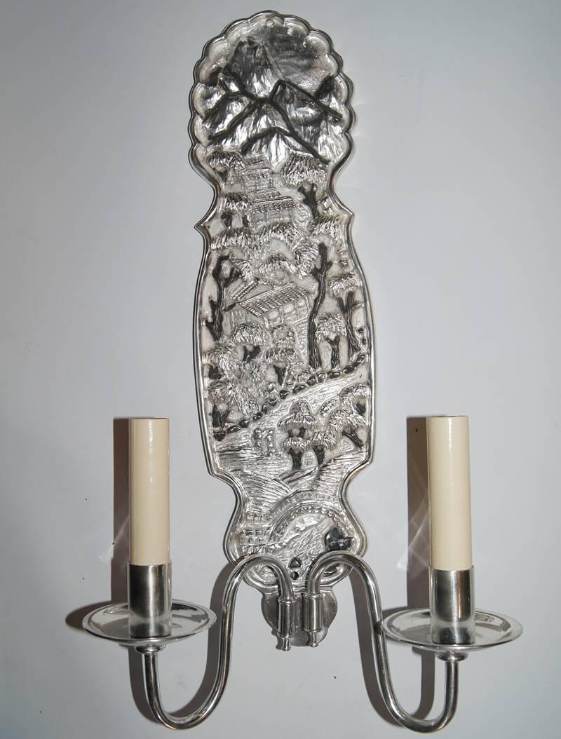 Pair of 1940s silver plated bronze Chinoiserie sconces with intricate scenes. Two arms each.
Measurements:
Height 18