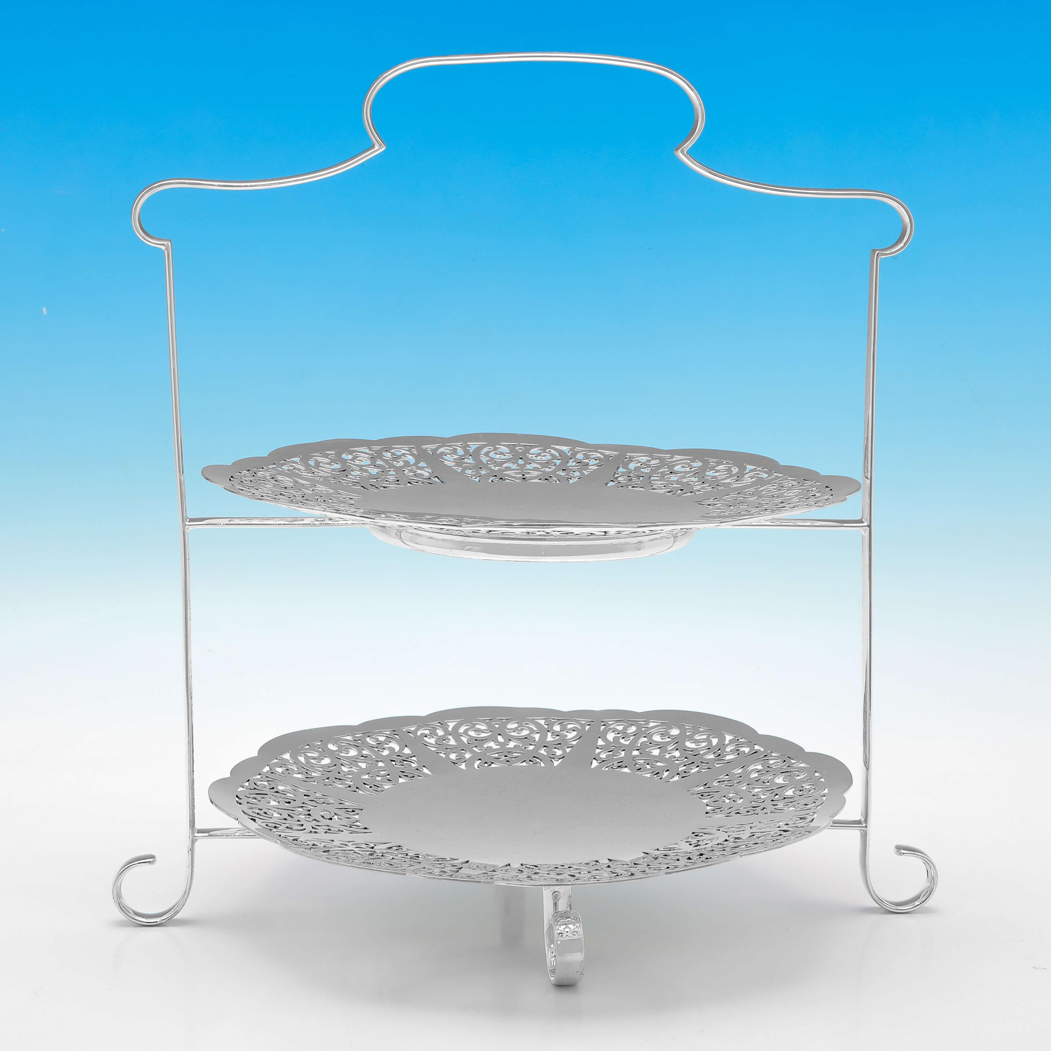Made circa 1920, this attractive pair of antique silver plated cake stands, each have 2 tiers, and feature plain shaped frames, and pierced plates. 

Each cake stand measures 12