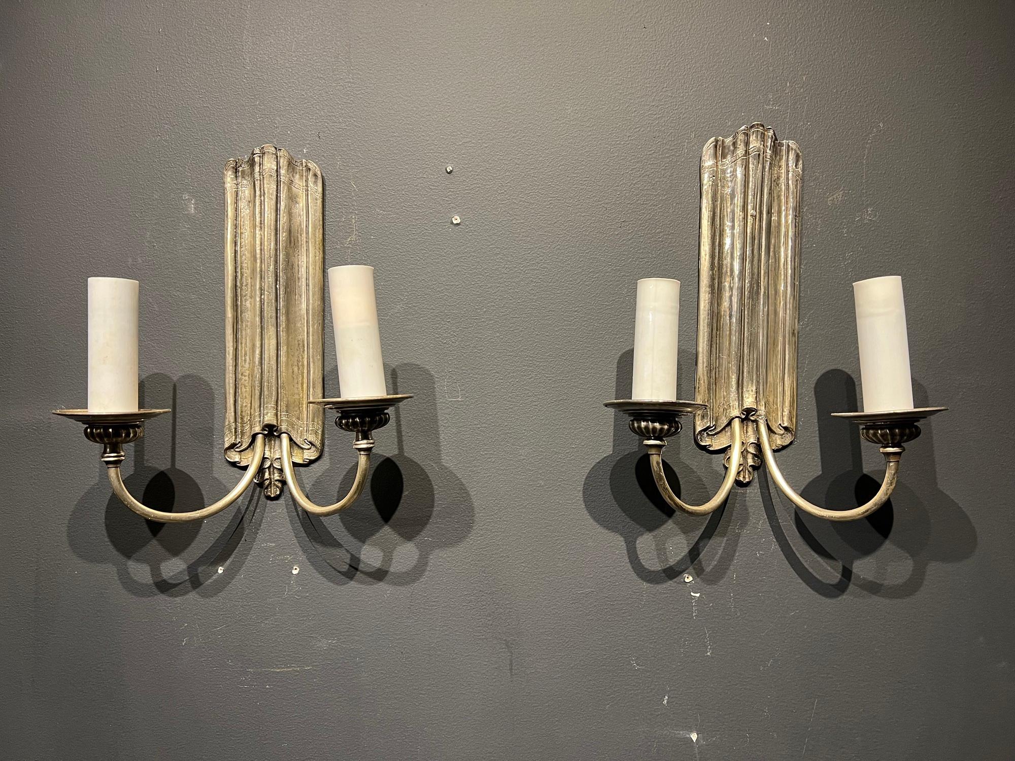 A pair of circa 1920’s Caldwell silver plated sconces. In very good vintage condition, no damage. 

Up to 120V (US Standard)
Hardwired

Dealer: G302YP