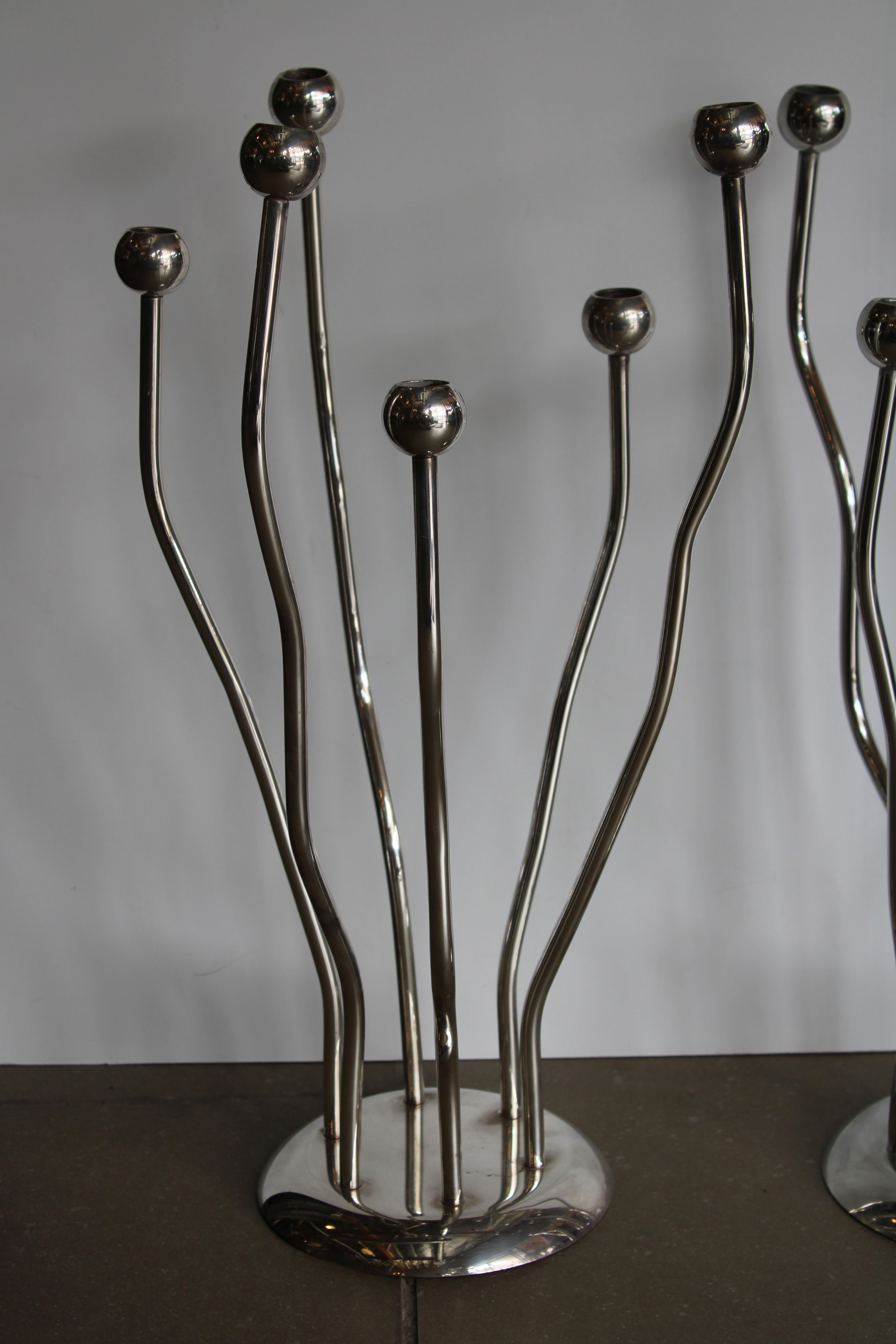 A pair of silver plated candelabras designed and produced in Italy by Mesa. 
 Each candelabra is stamped on the bottom. They each measure about 20