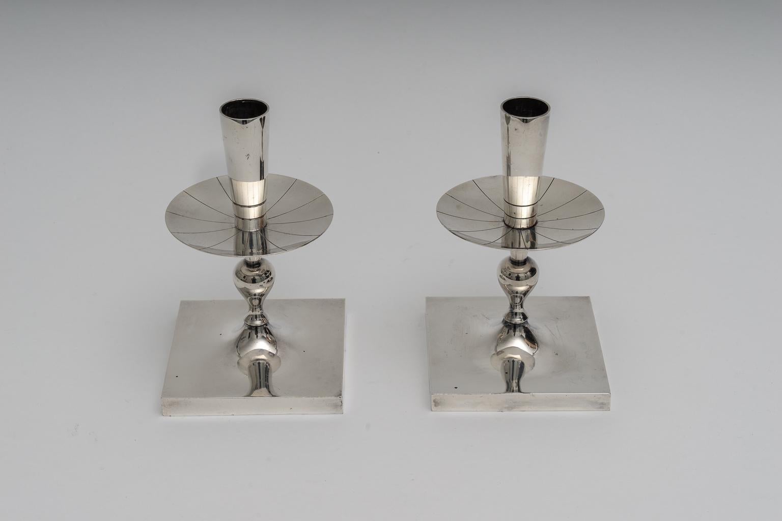 This stylish set of silver plated candlesticks were designed by the iconic designer Tommi Parzinger and date to the 1960s.

Note: On the verso Heirloom 