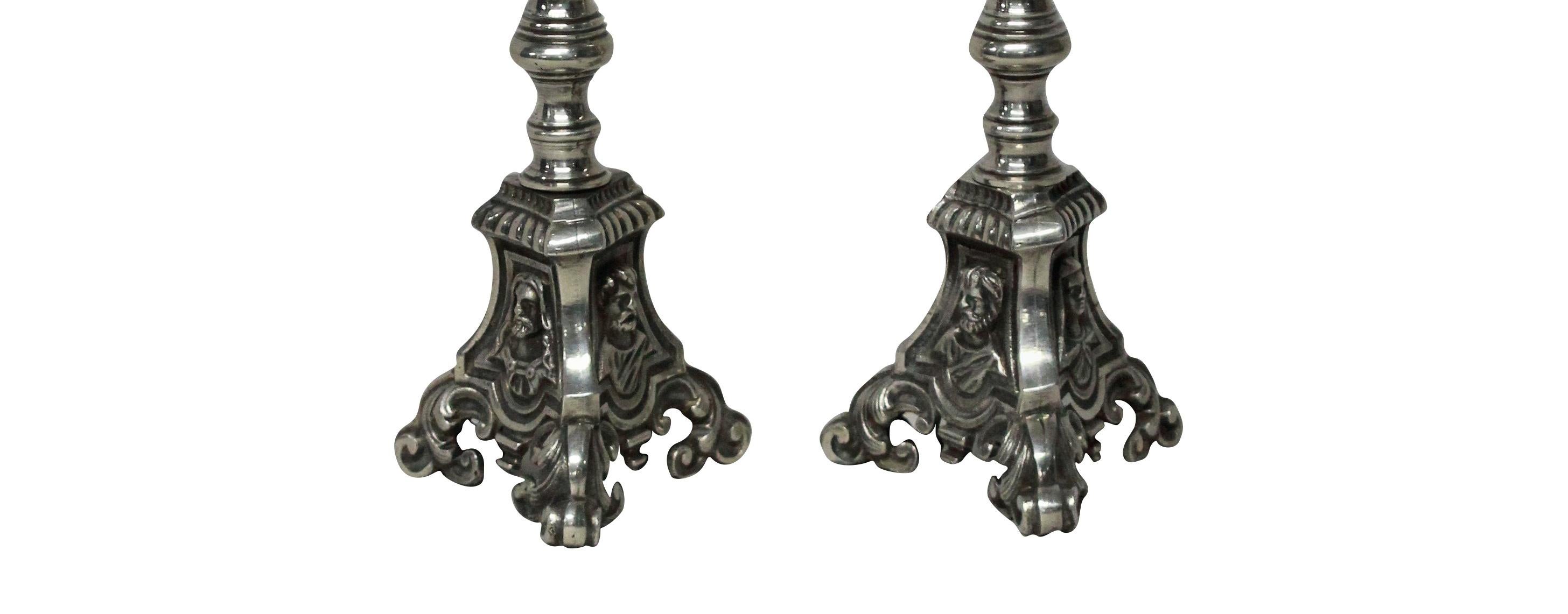 A pair of French silver plated bronze candlesticks, depicting saints at the base. Would make great electrified lamps for a fireplace.

  