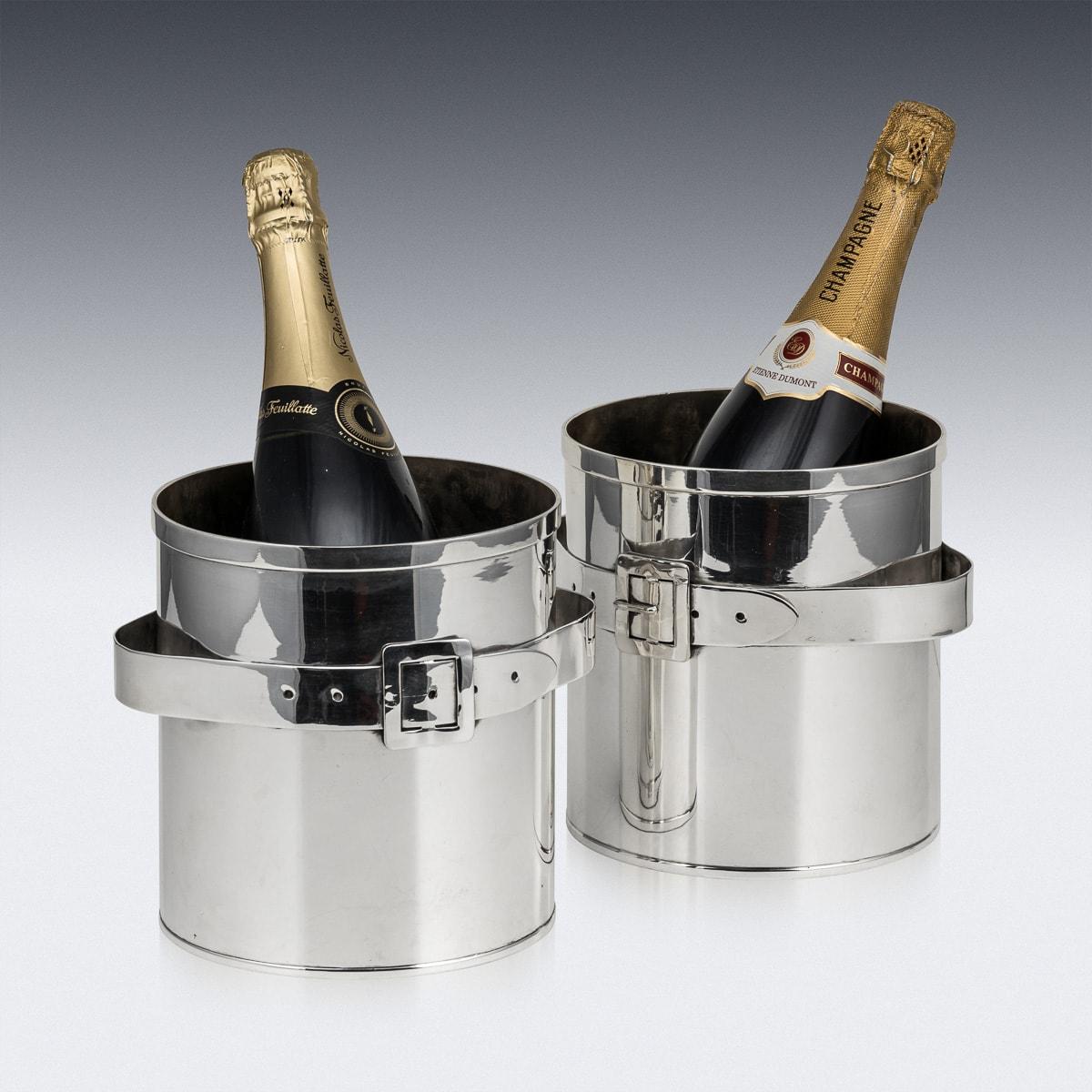 A superb pair of mid-20th Century silver plated ice buckets. The buckets are adorned with a brass belt buckle detail and offers ample space to accommodate a bottle of champagne. They serves as an ideal enhancement for any home, whether contemporary