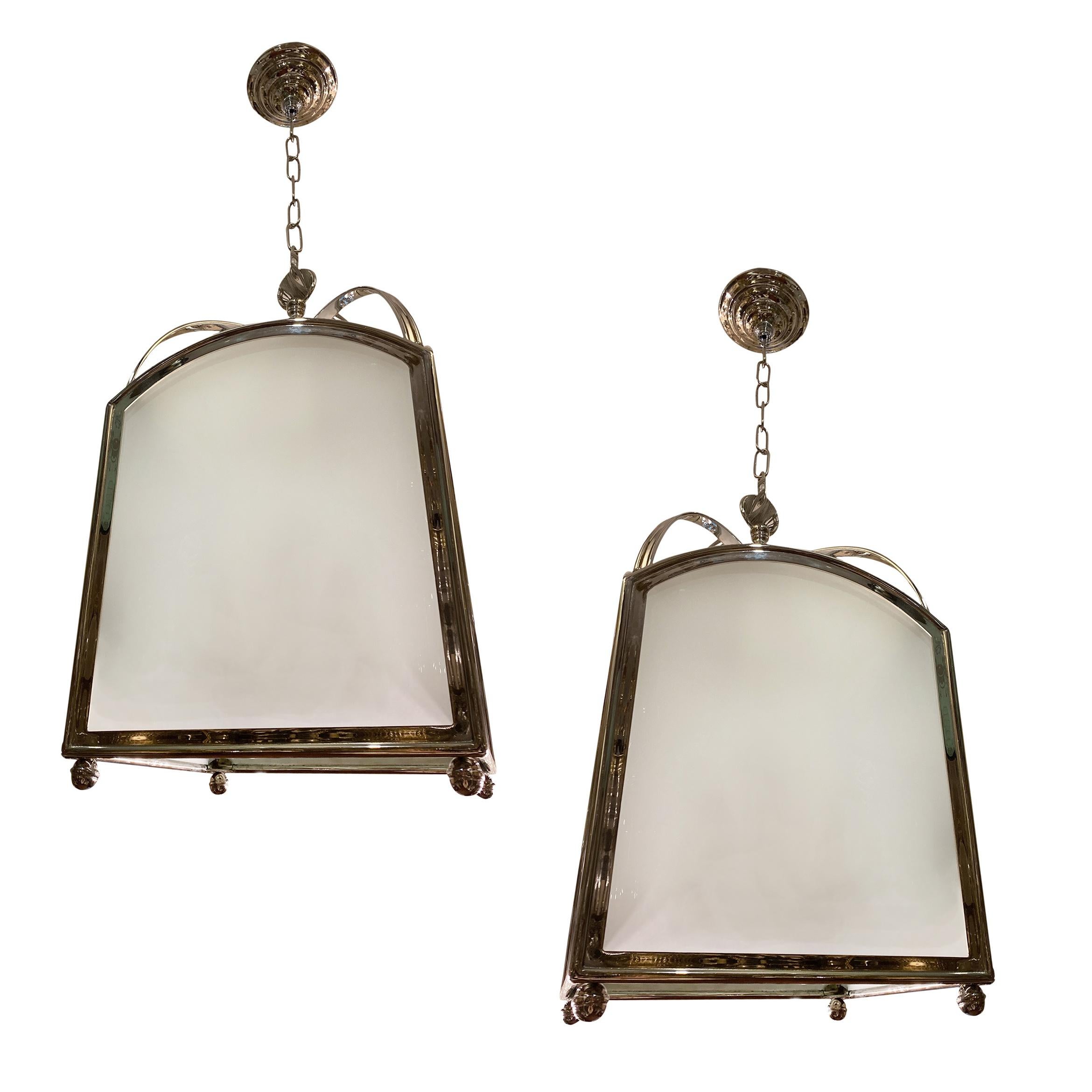 Pair of circa 1950s English silver-plated lanterns with four interior candelabra lights each and frosted glass insets. Sold individually.

Measurements:
Current drop 40
