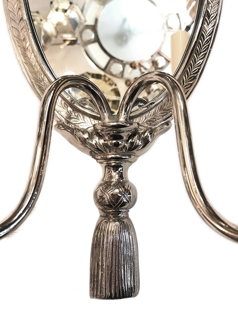 Pair of circa 1940s American silver-plated sconces with mirror back.

Measurements:
Height 23.25