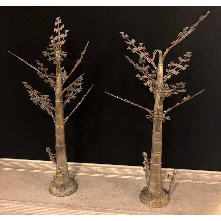 Silver Plated or Steel Metal Figural Sculptures of Men Climbing a Tree, a Pair 
Pair of silver plated or steel metal figural sculptures. Possibly Indian or German made in the 1970s. The sculptures features several people and birds on a tree. The