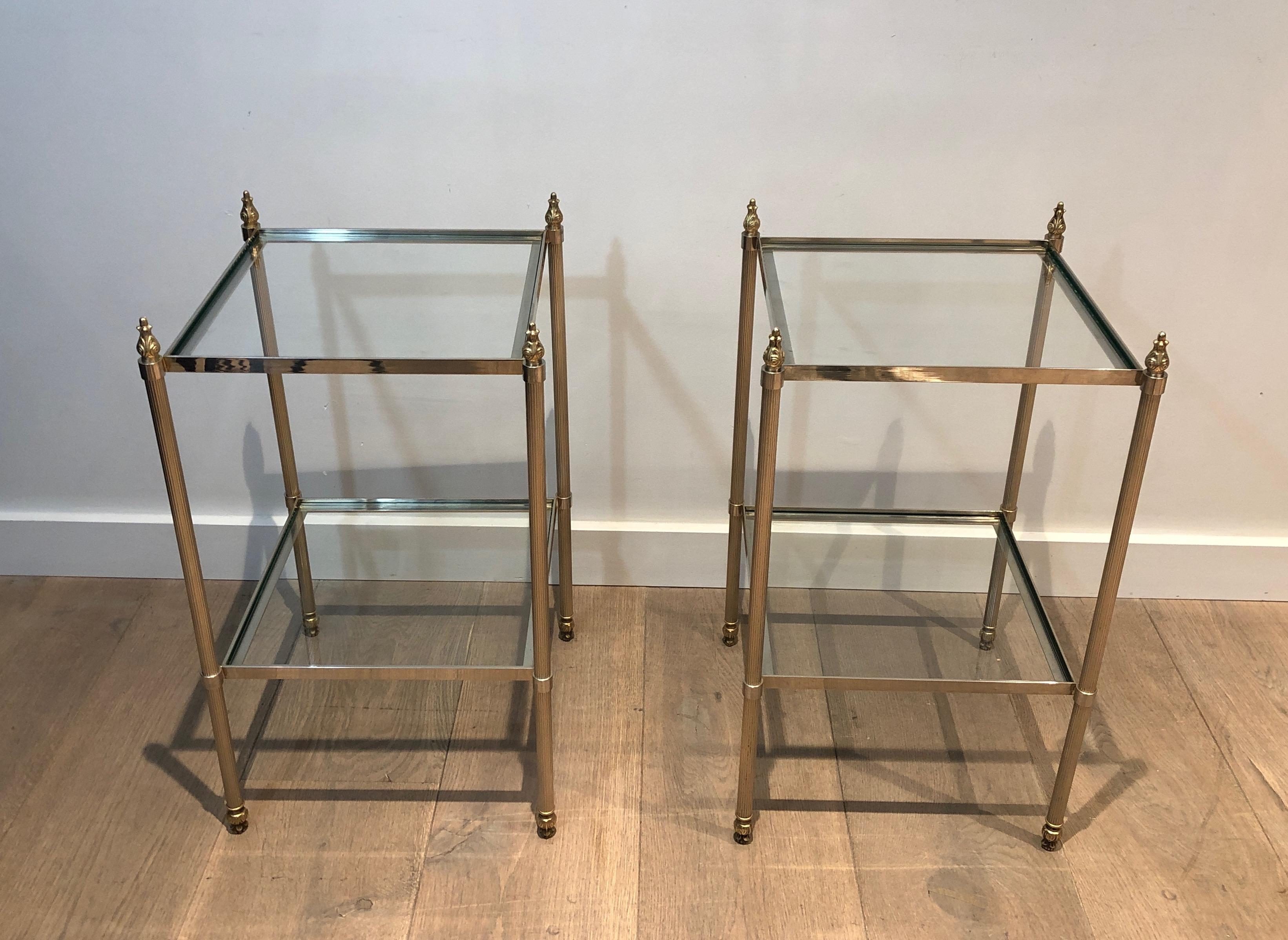 This very nice and elegant pair of side tables is made of silver plated on brass with 2 tiers and fluted legs. This is a French work attributed to Maison Jansen. Circa 1940
