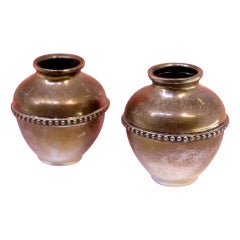 Pair of silver pots with pearly friezes around the edges