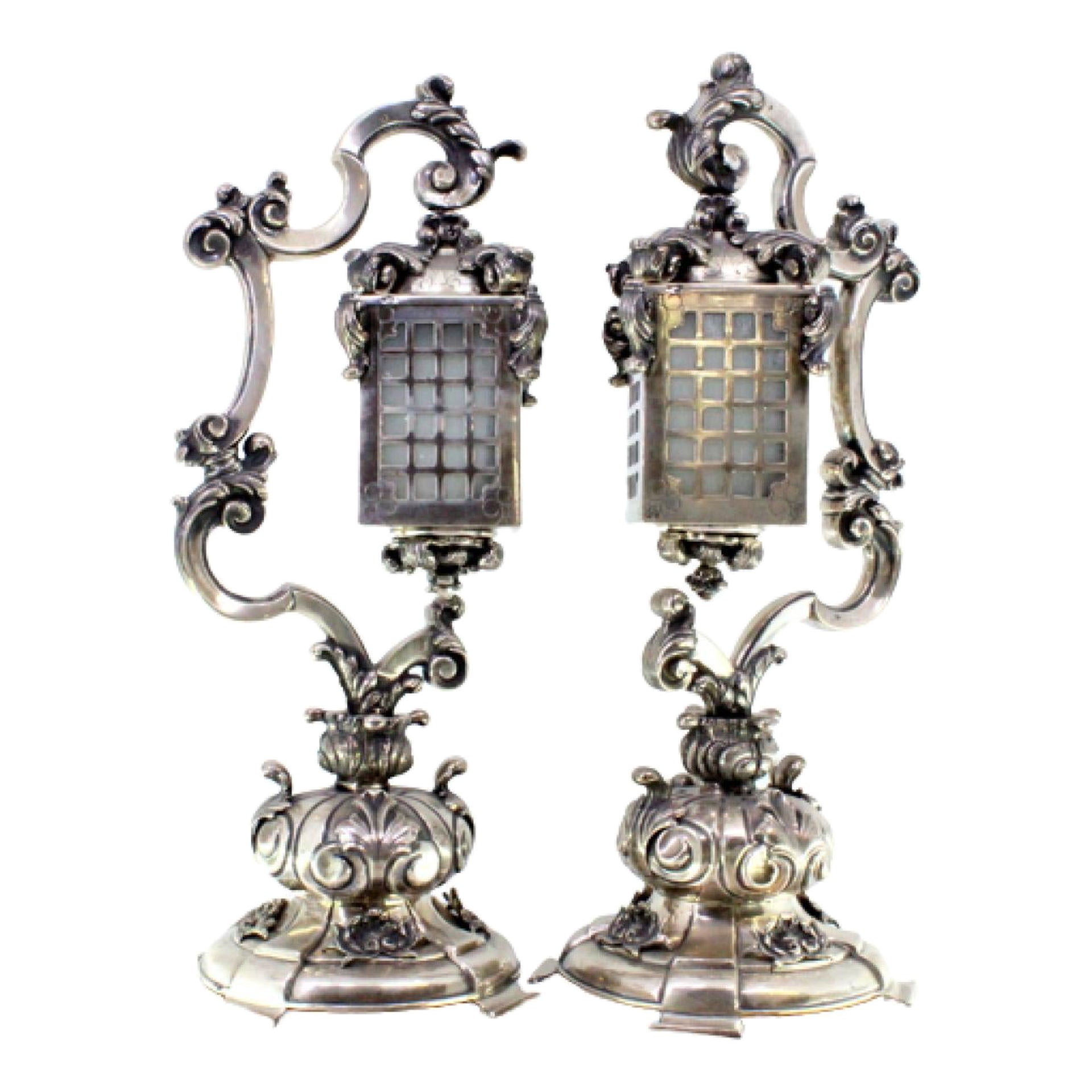 Pair of silver table lamps with reliefs and applications on shell bases For Sale
