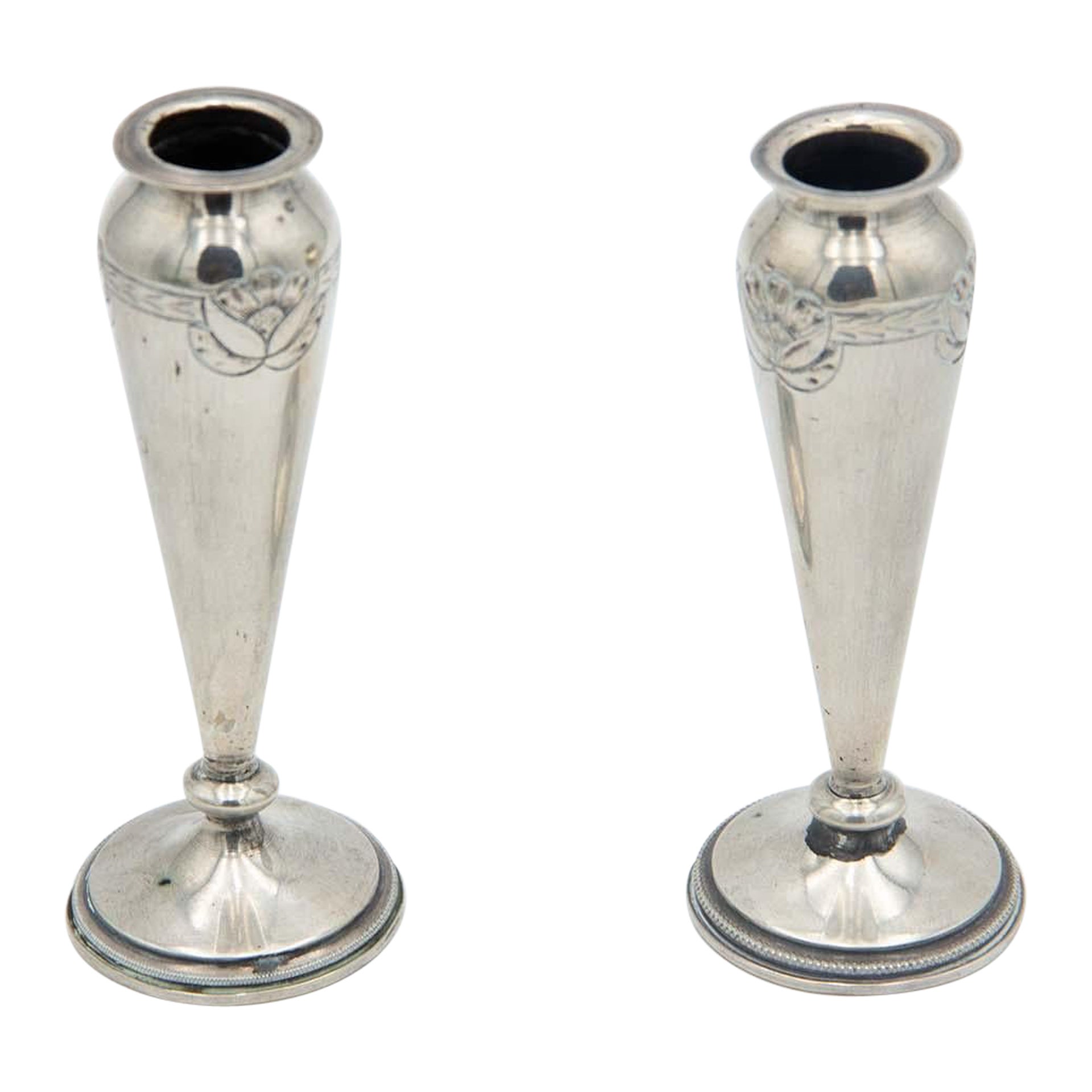 Pair of silver vases with floral reliefs