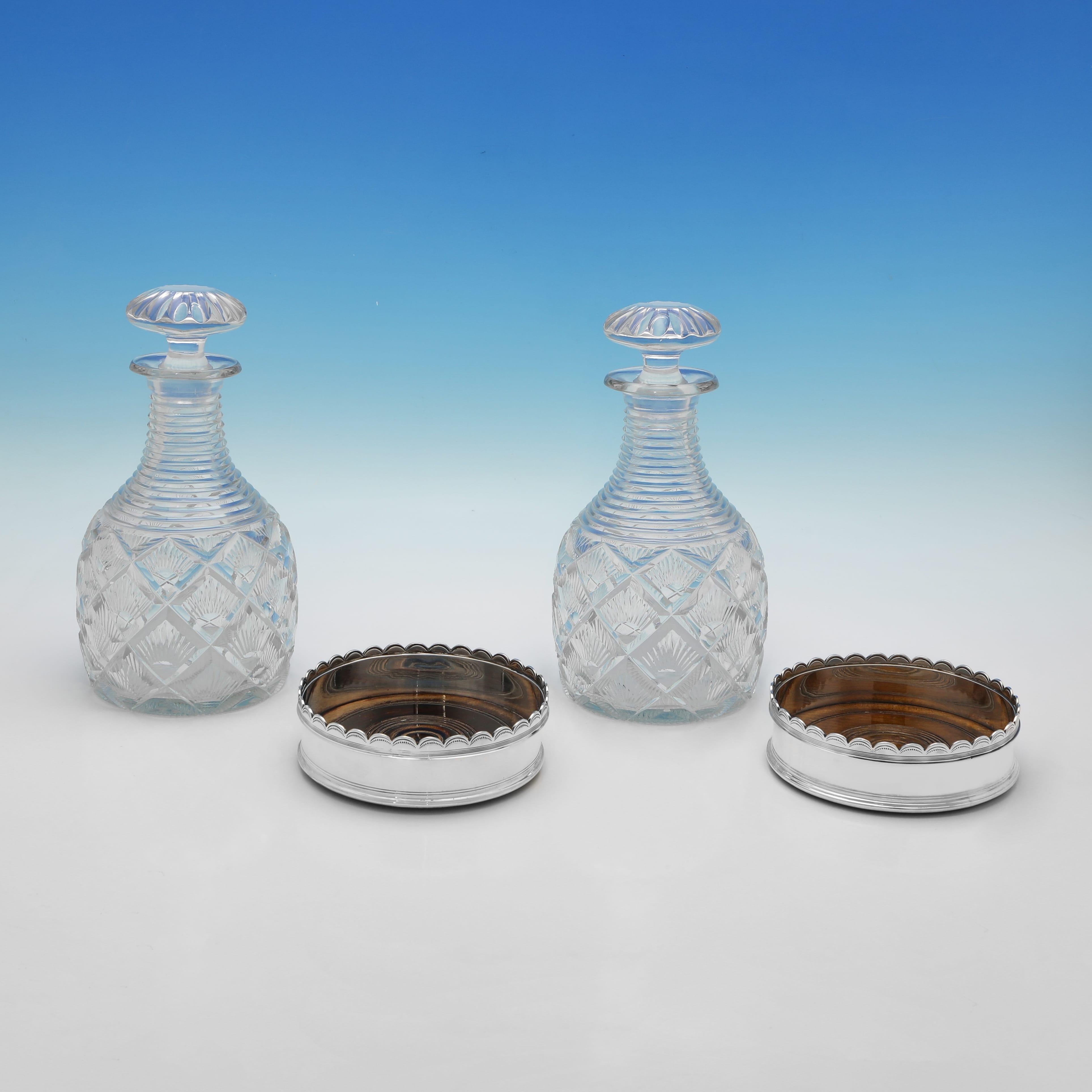 Hallmarked in Sheffield in 1927 by Mappin & Webb, this charming pair of Sterling Silver WIne Coasters & Glass Decanters, would make a handsome addition to any table. The decanters measure 9.5