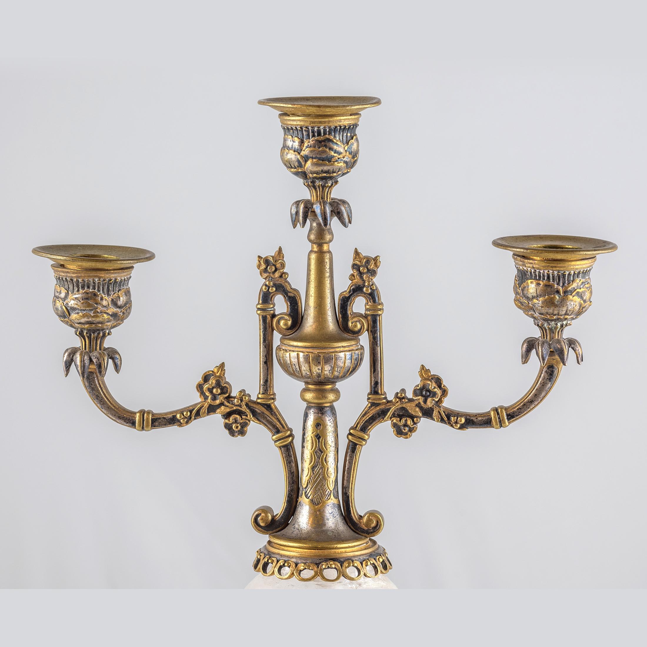 A charming pair of silvered and gilt bronze rock crystal three-light candelabra in chinoiserie motif

Origin: French
Date: 19th Century
Dimension: 16 1/2 inches high.