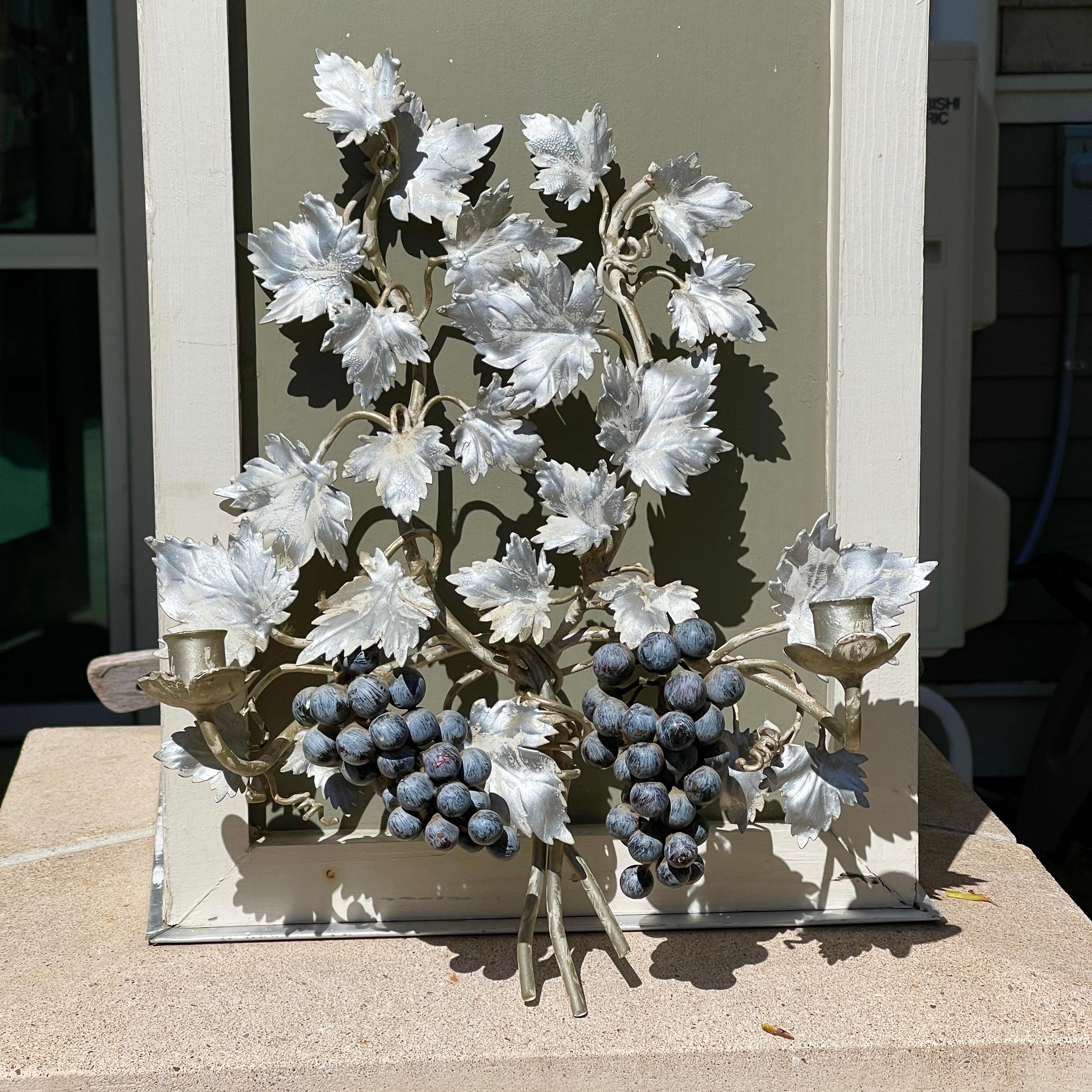 Vintage pair of Italian grape vine wall sconces hand painted, silvered and white washed, with dual arms for tapered wax candles. If requested we can modify these for use with candelabra size lightbulbs with external wiring. Hefty and well crafted.