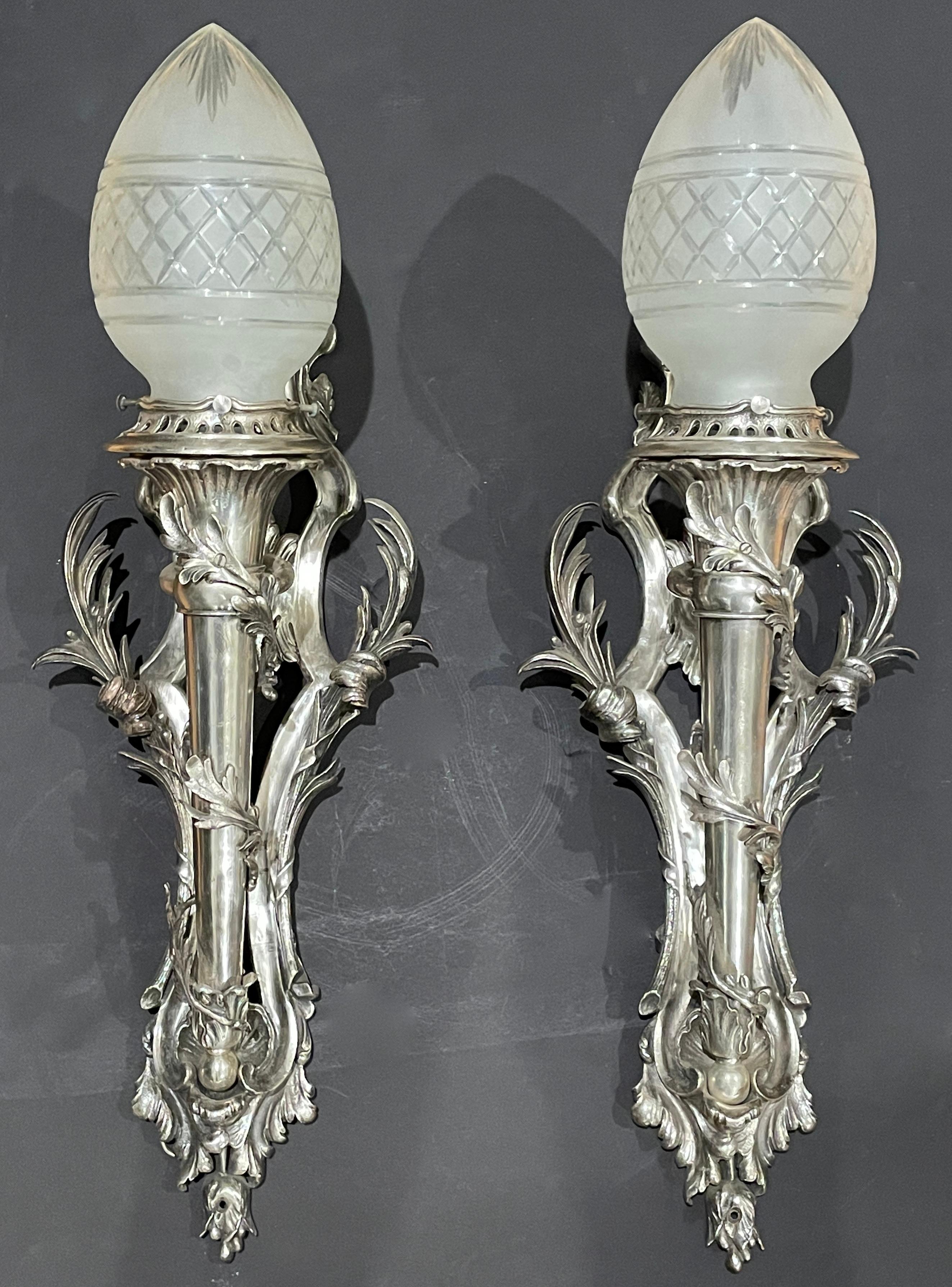 Fine quality silver over bronze Louis XV style wall sconces with frosted cut to clear torch form glass globes. Wall torchiere form sconces recently rewired with a projection of 10