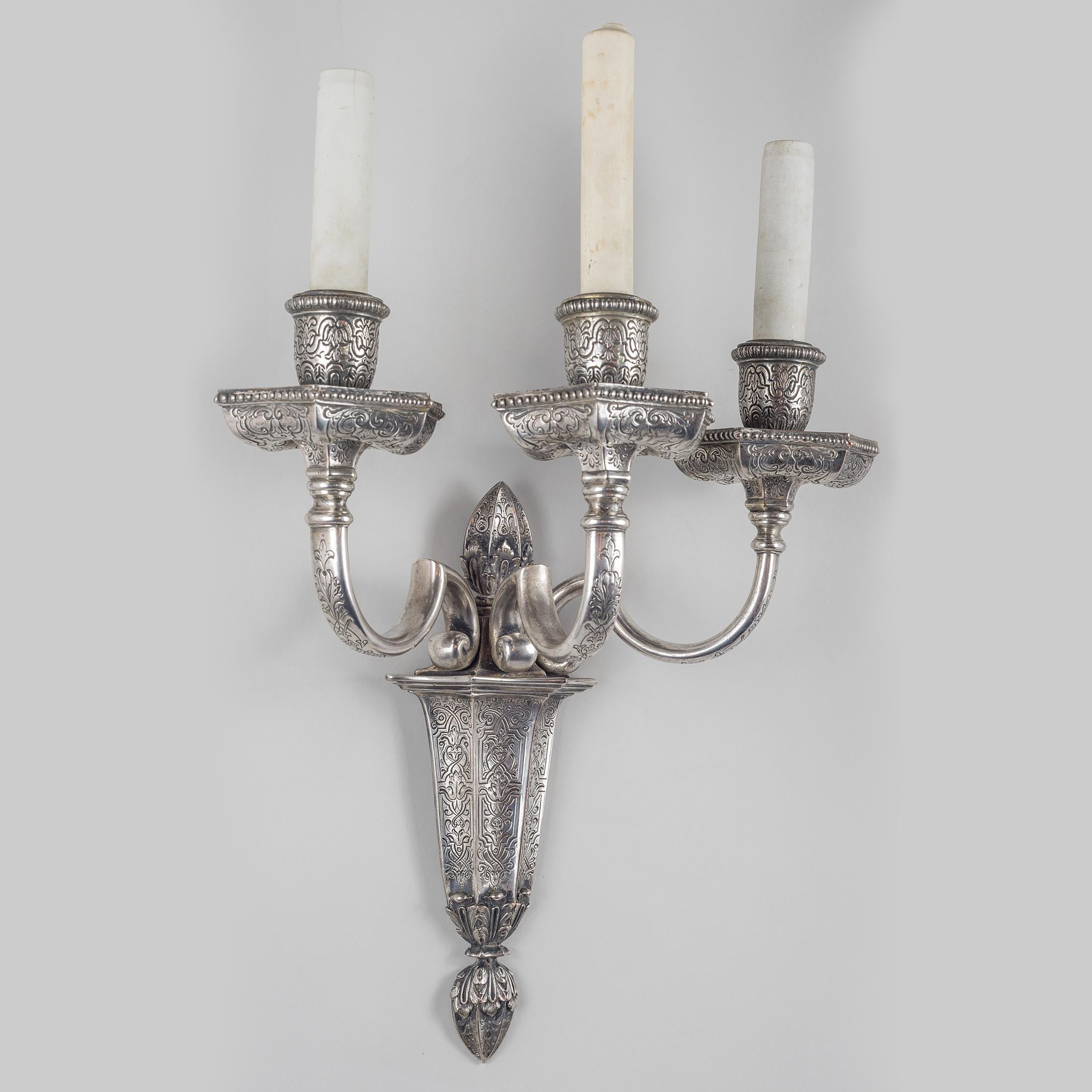 A fine quality pair of silvered bronze three-light caldwell sconces in Moorish style with engraved and cast decoration.

Maker: Edward F. Caldwell Co. (1851-1914) 
Origin: American
Date: 19th century
Dimension: 20 inches high; 8 inches depth.