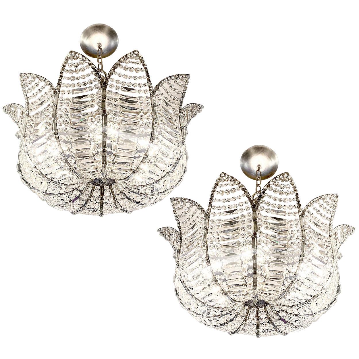 A pair of 1960's French silver leaf light fixtures with crystal insets and 12 interior lights. Sold Individually

Measurements:
Current drop: 36?
Diameter: 34.5?
Height of body: 15