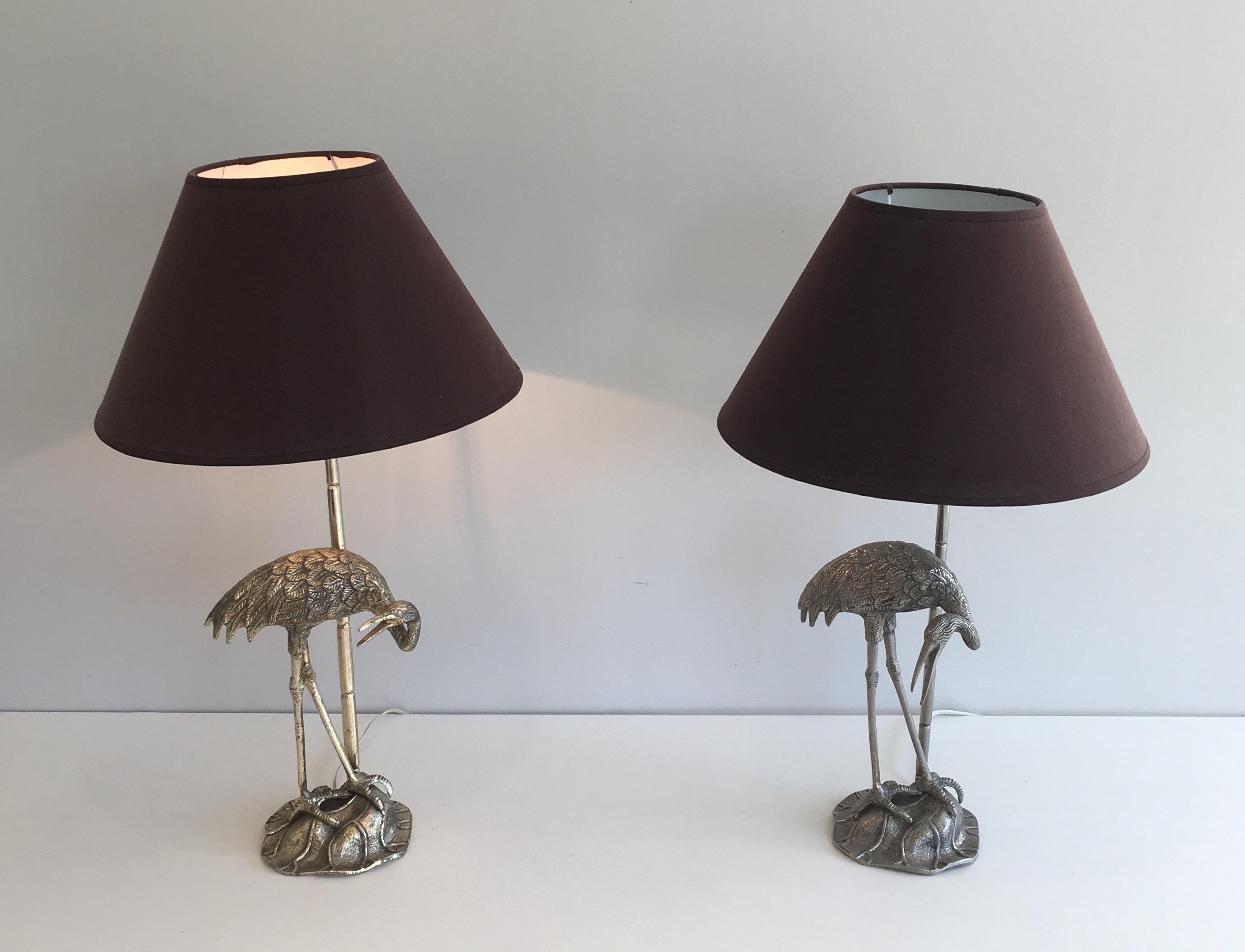 This pair of herons table lamps is made of silvered metal. This is a French work by Maison Bagués. Circa 1940
