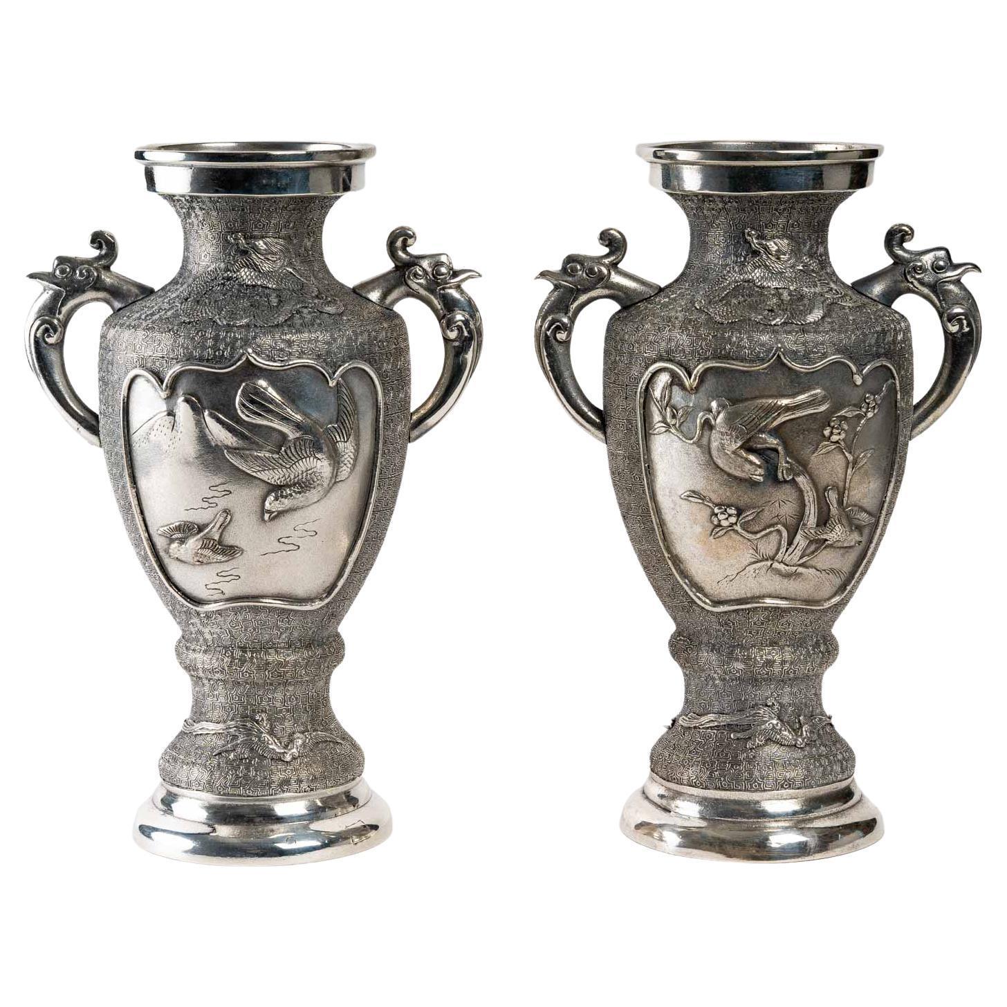 Paire de vases en métal argenté, Asie, début du 20e siècle. Décorée de dragons et d'oiseaux.
Dimensions H : 31,5, L : 23 cm, P : 16 cm.