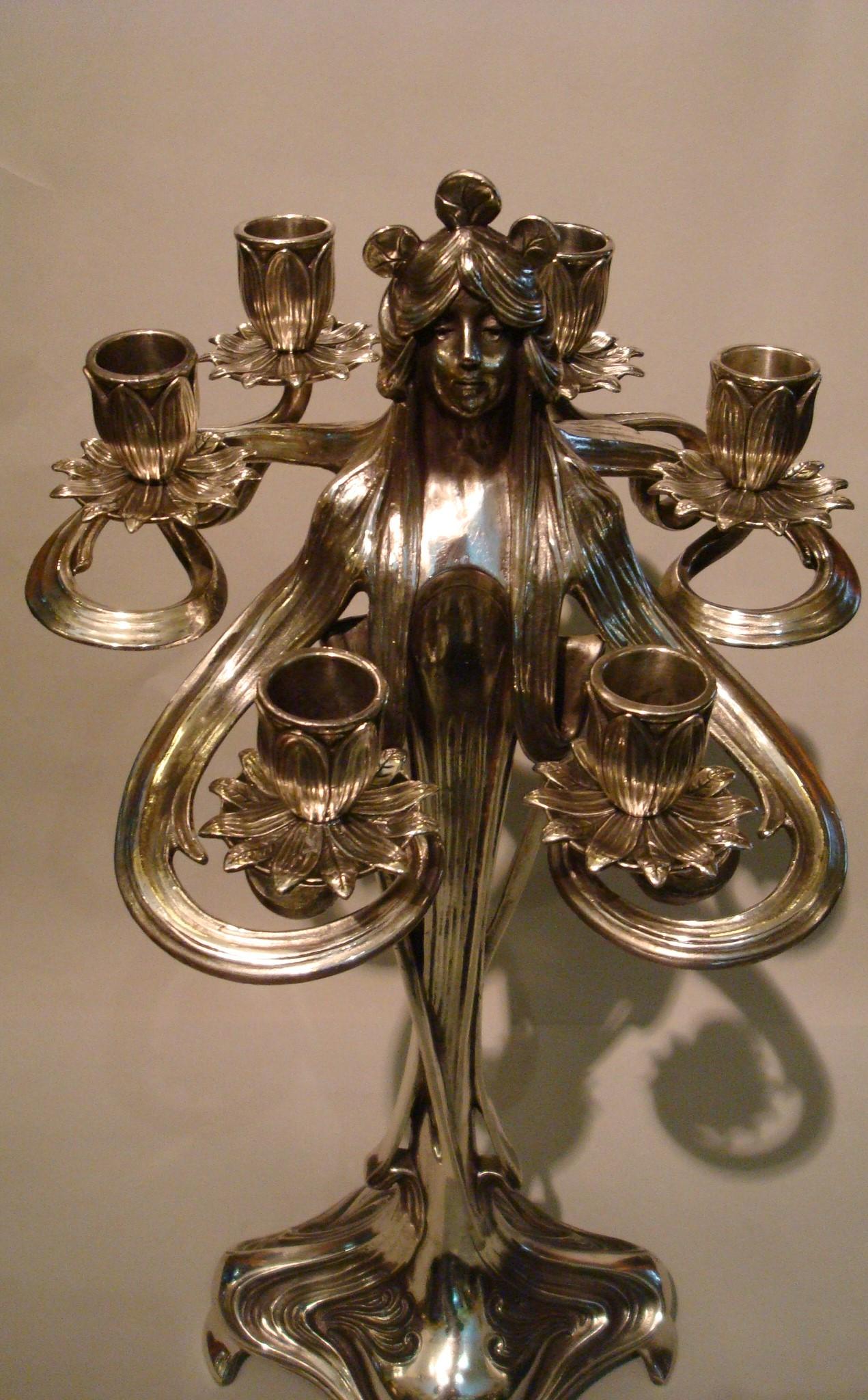 Art Nouveau silvered Pewter Candelabra a pair
Pair of Art Nouveau silvered pewter candelabra / candleholder
with female figure surrounded by 6 arms for six candles (probably WMF) 
Each cast in the form of a longhaired female form who seemingly