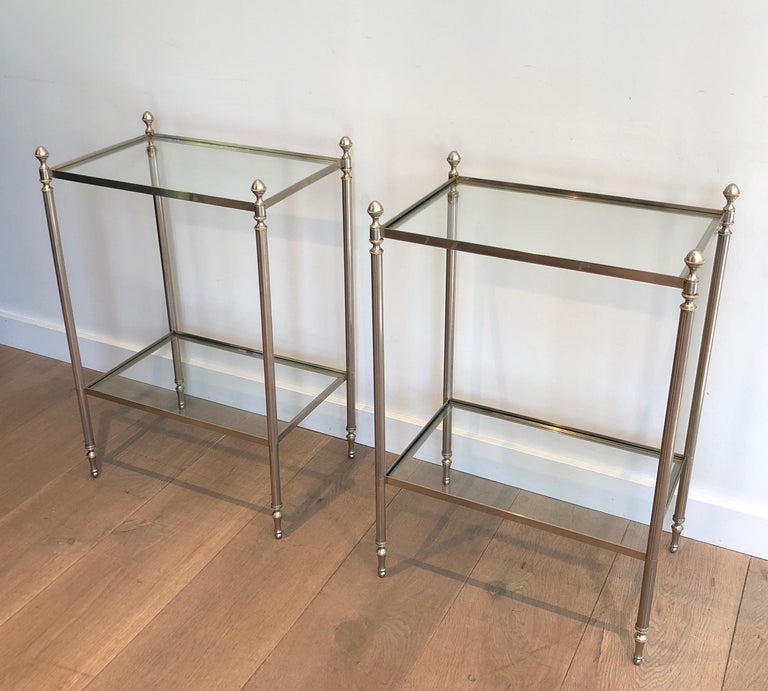 This pair of neoclassical style side tables is made of silvered brass. These end tables with 2 tiers have nice finials, Beaded legs. This is a French work in the Style of Maison Jansen. Circa 1940.