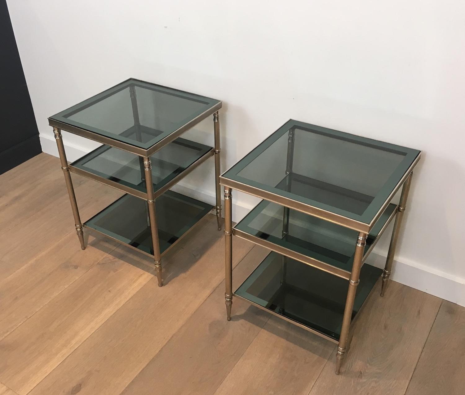 Attributed to Maison Jansen. Pair of silvered side tables with blueish glass shelves, French, circa 1960.