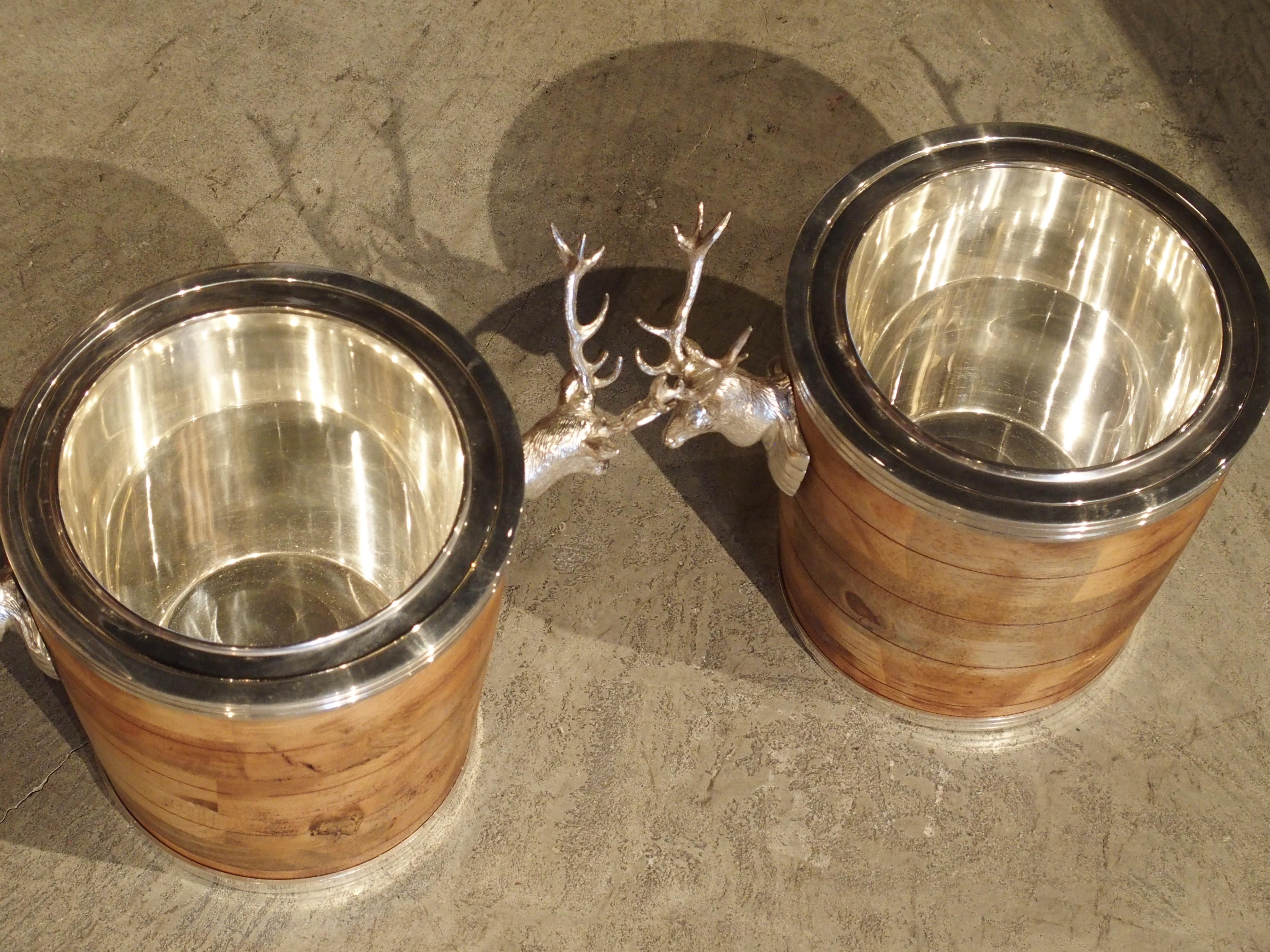 20th century

These remarkable wine coolers are comprised of silver plated ice buckets, which sit inside larger wooden surrounds. Silverplate stag heads on either side of the wood buckets function as handles, and on the centre, are bright