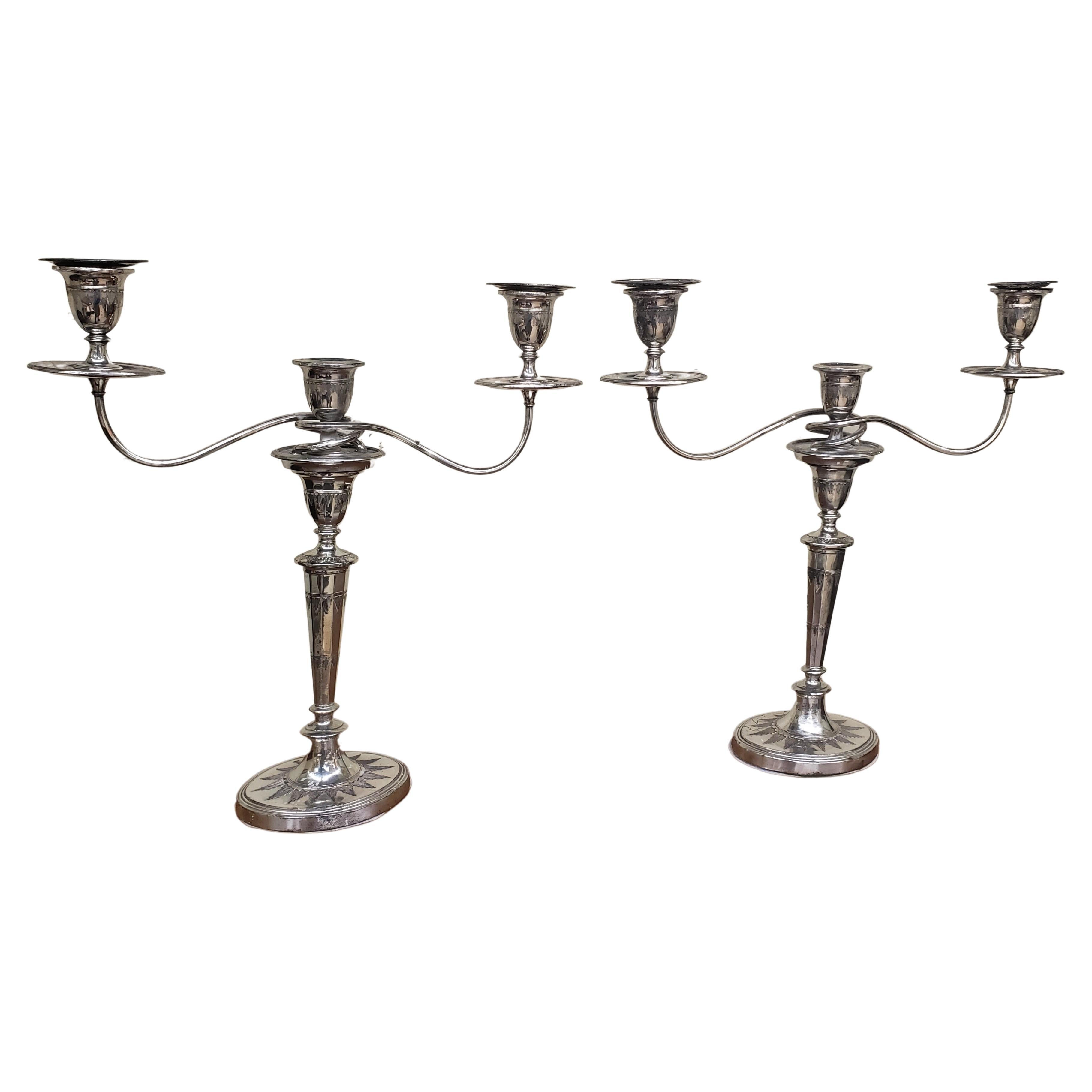 Pair of silverplate convertible three-light candelabra. Measure 18 inches wide, 4 inches deep, 19 inches tall. Oval base is 6 inches wide.