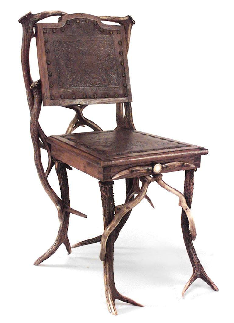 Pair of similar Rustic German (19th Cent) oak & antler side chairs with carved medallions and embossed brown leather seat & back with nailhead detail. (matching sofa: 059336)
