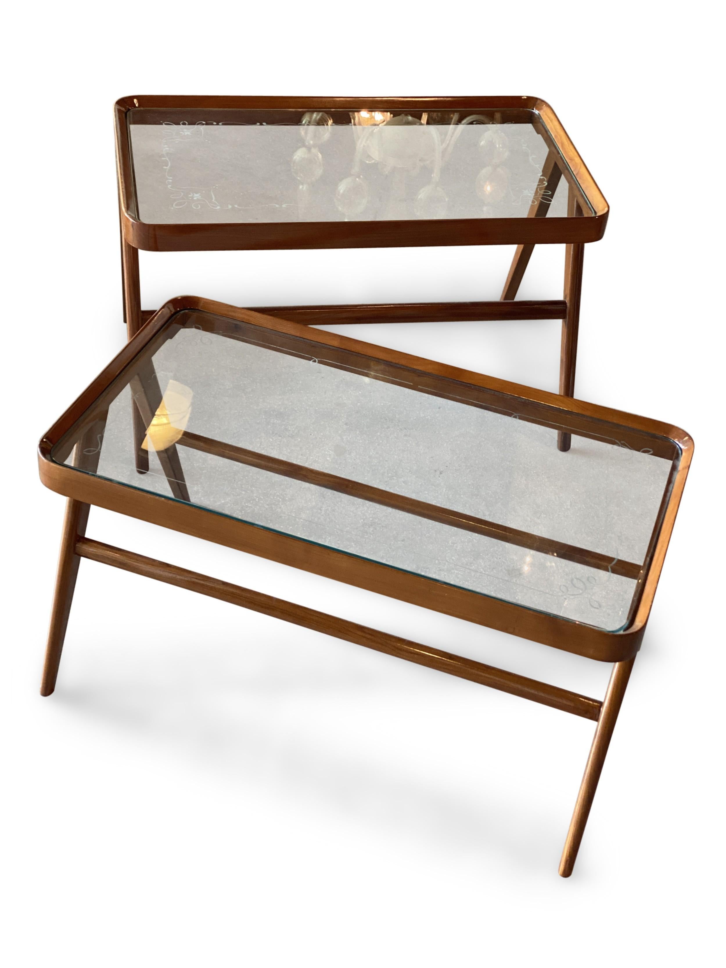 Pair of similar Italian Mid-Century cherrywood low end tables with an intricately etched glass top resting on V shaped tapered legs connected by a stretcher (PRICED AS Pair) (CARLO DE CARLI)

Smaller table is: 32.5W x 18D x 17.5H
