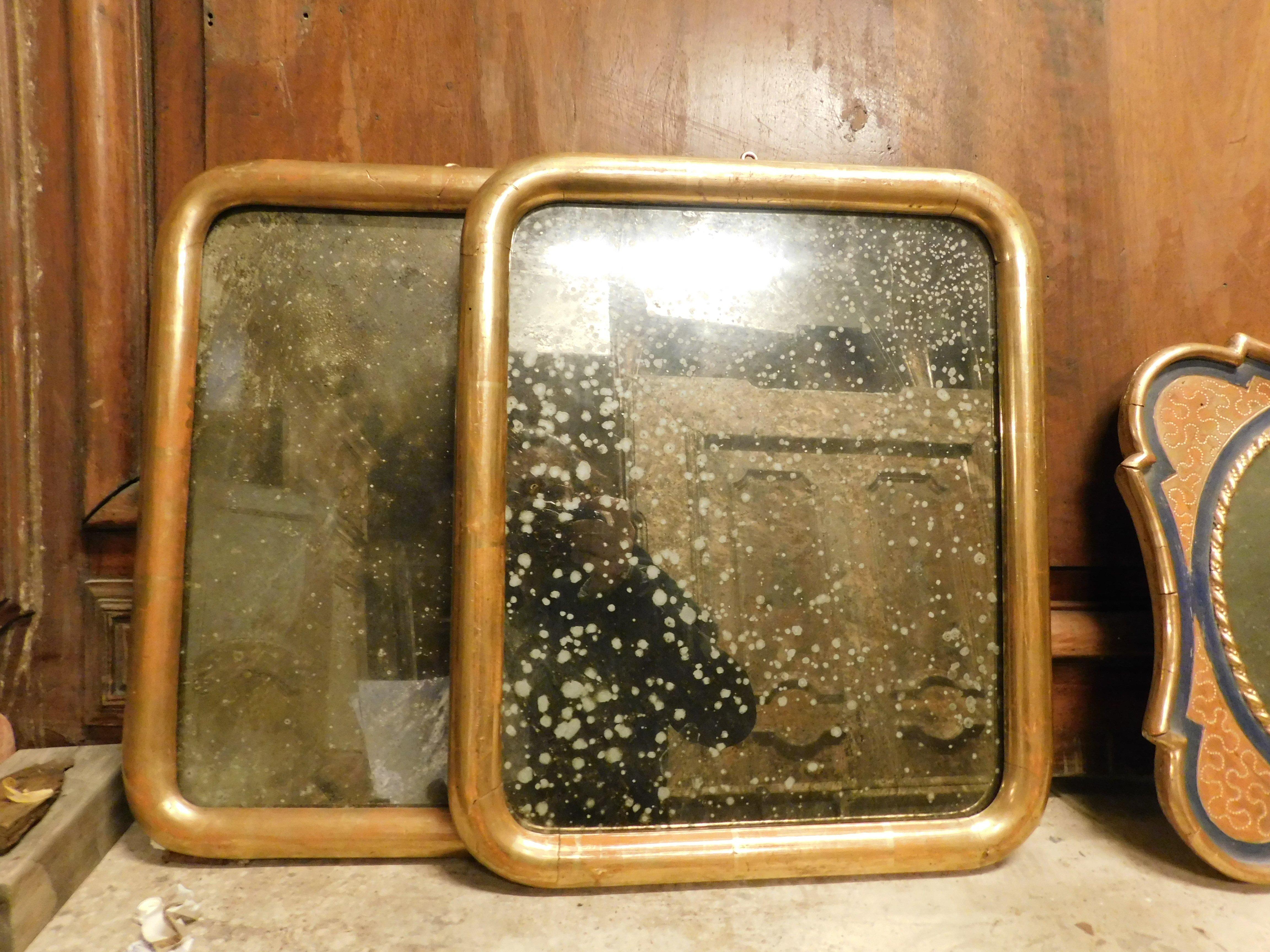 Pair of simple gilded wooden mirrors. Original from the 1900s. Origin: Turin (Italy), original mirror. On the back there is a plate with the gilder's name: Raposso Carlo. Measurements: cm w 35 x H 42