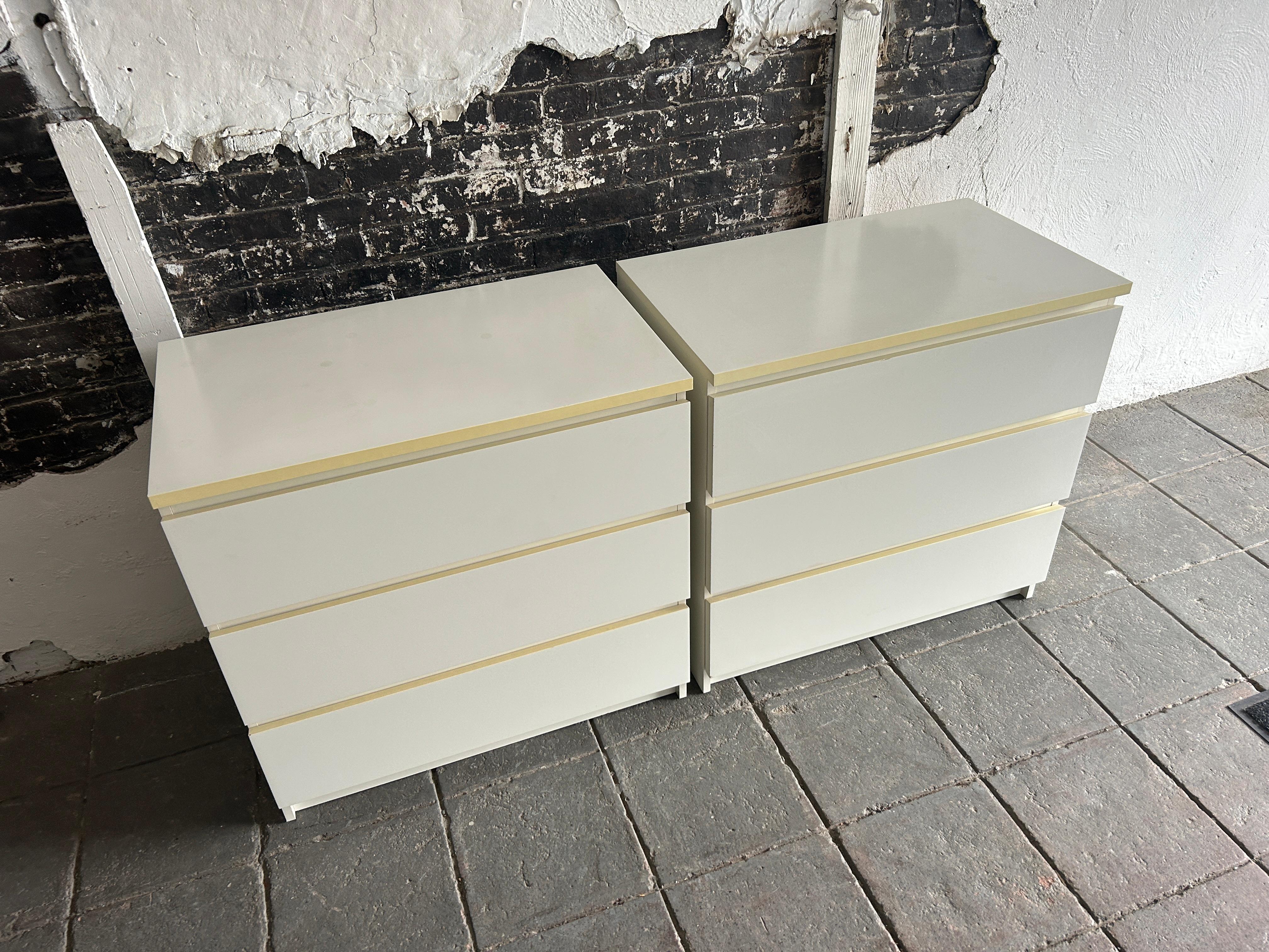 Simple pair of Post Modern 3 drawer white Laminate dressers.. All white laminate  construction. All drawers on glides and slide smooth and are clean inside. This listing is for (2) dressers (1) pair. Located in Brooklyn NYC.