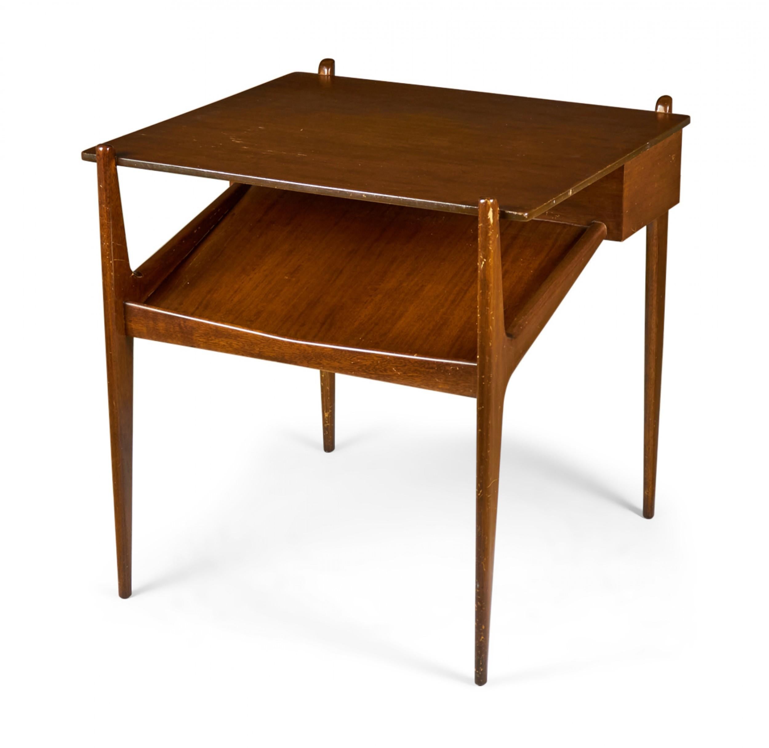 PAIR of American Mid-Century walnut end / side tables with a square top and magazine shelf attached to the top at an acute angle framed by four tapered walnut legs. (SINGER & SONS)(PRICED AS PAIR)
