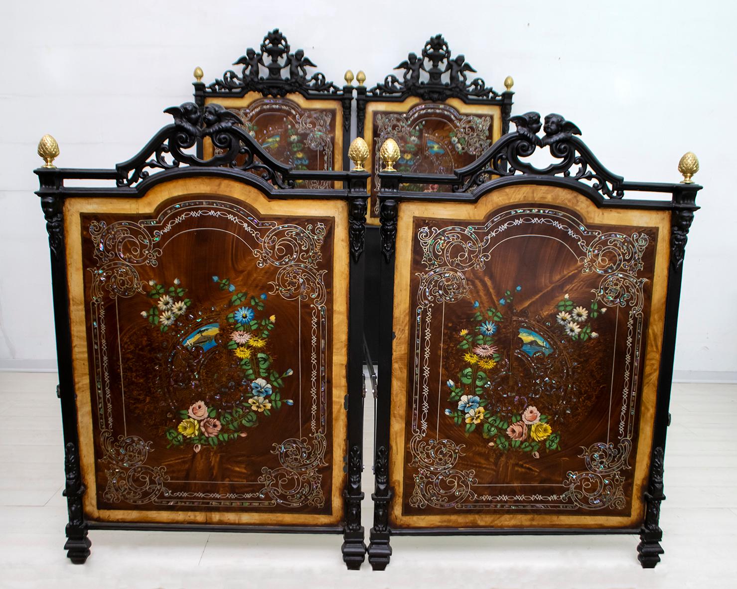 Beautiful pair of Italian Art Nouveau single beds. The two beds are made of iron with hand forged decorative motifs, they can be joined to form a double bed of European size. The panels have a refined hand painted floral decoration. Precious pearl