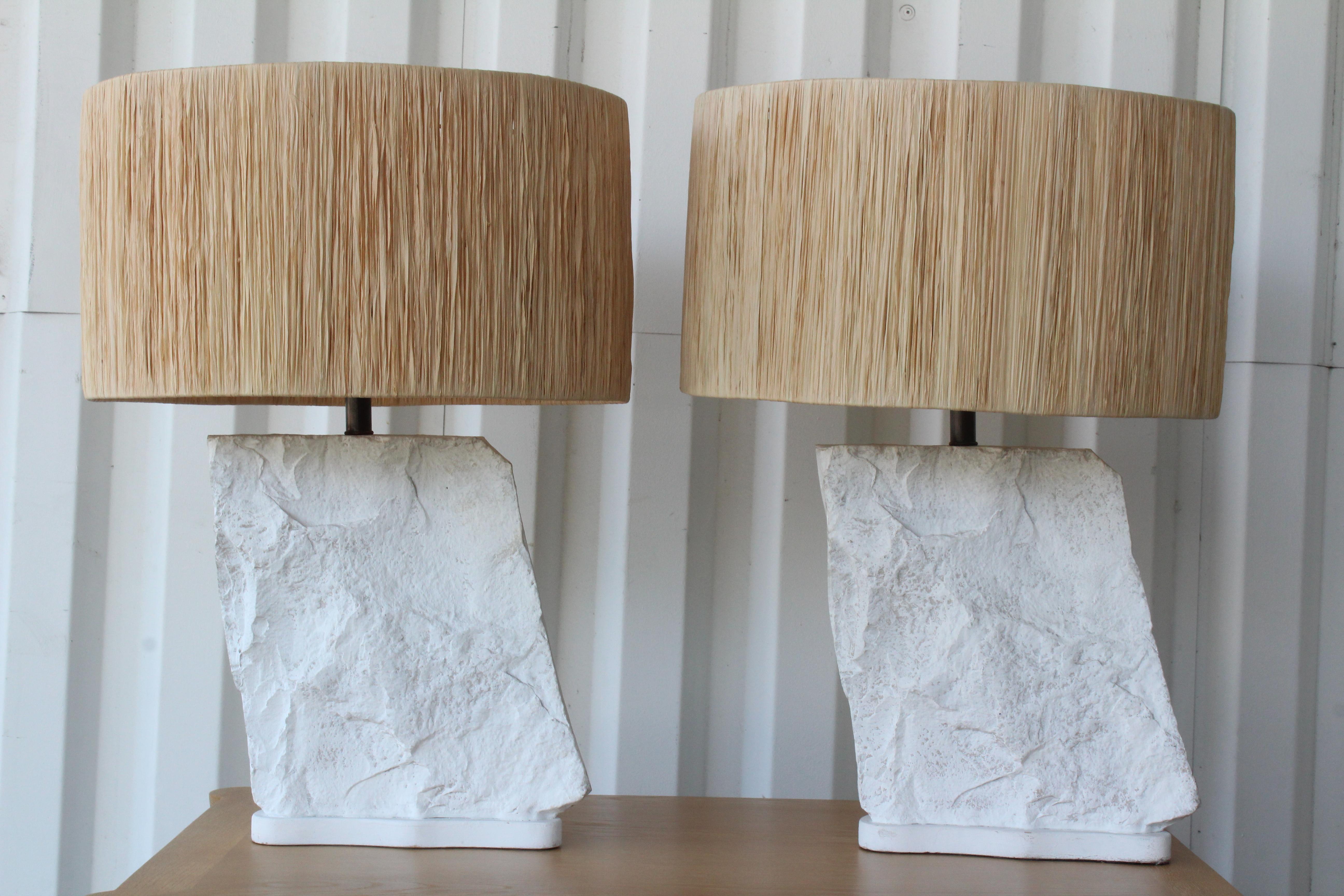 Pair of plaster rock lamps by Sirmos, made in France in the 1970s. The pair have been rewired and include custom made raffia shades. The lamps are 25