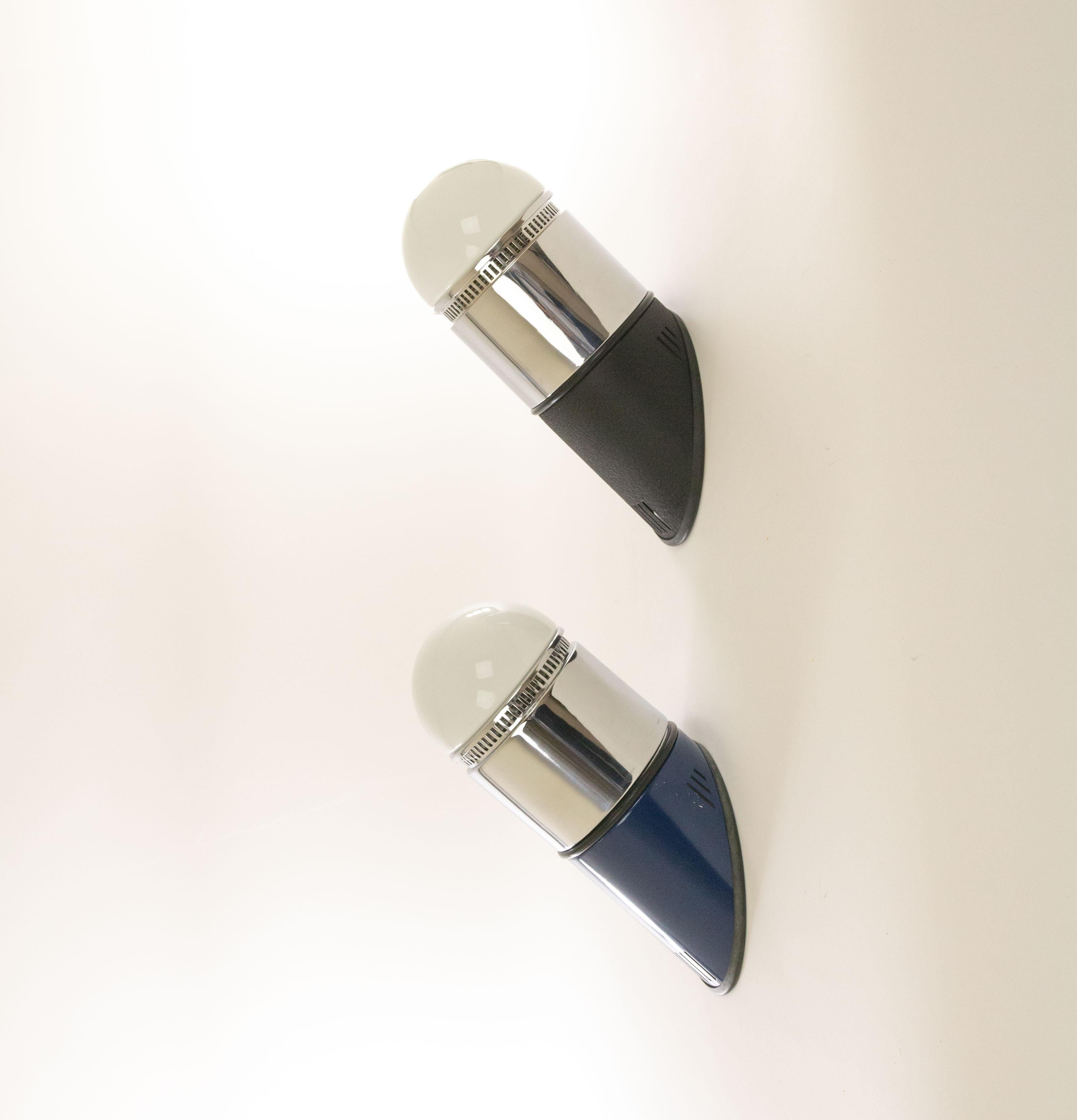 Blue and black pair of Sisten wall lamps designed by Gianni Celada and produced by Fontana Arte, 1973.

These wall lamps are part of the Sisten series; consisting of various wall and ceiling lamps, all with (interchangeable) opaline glass and