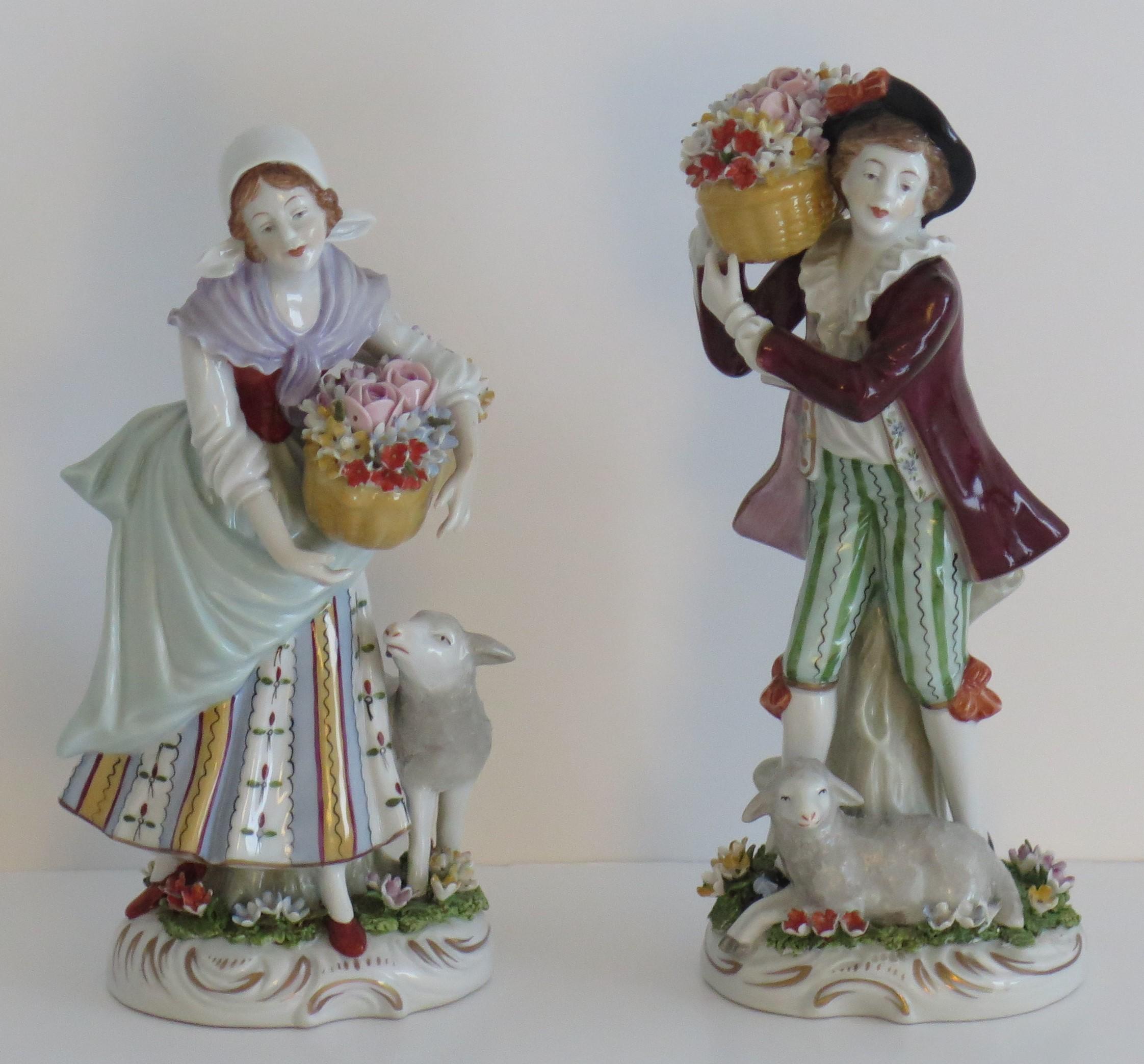 These are a beautiful PAIR of porcelain Figures or Figurines made by Sitzendorf, Germany, circa 1920.

The figures are finely modelled in very good detail. They depict two flower sellers with a young man and woman in traditional country dress