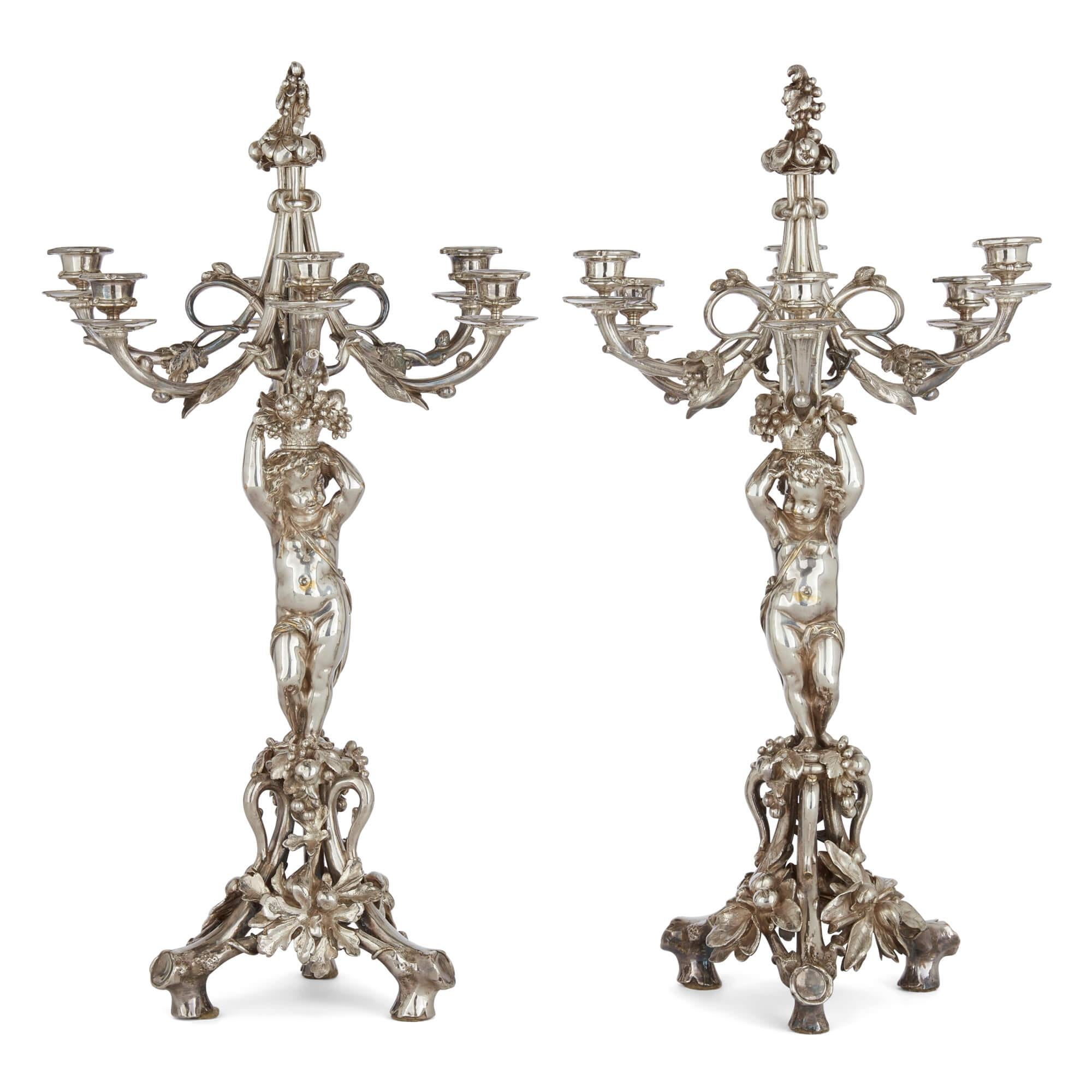 Pair of six-light silvered bronze candelabra attributed to Christofle 
French, 19th Century
Height 65cm, diameter 37cm

This superb pair of candelabra are crafted in the opulent Rococo style. Standing atop three trunk-style feet, the bases feature