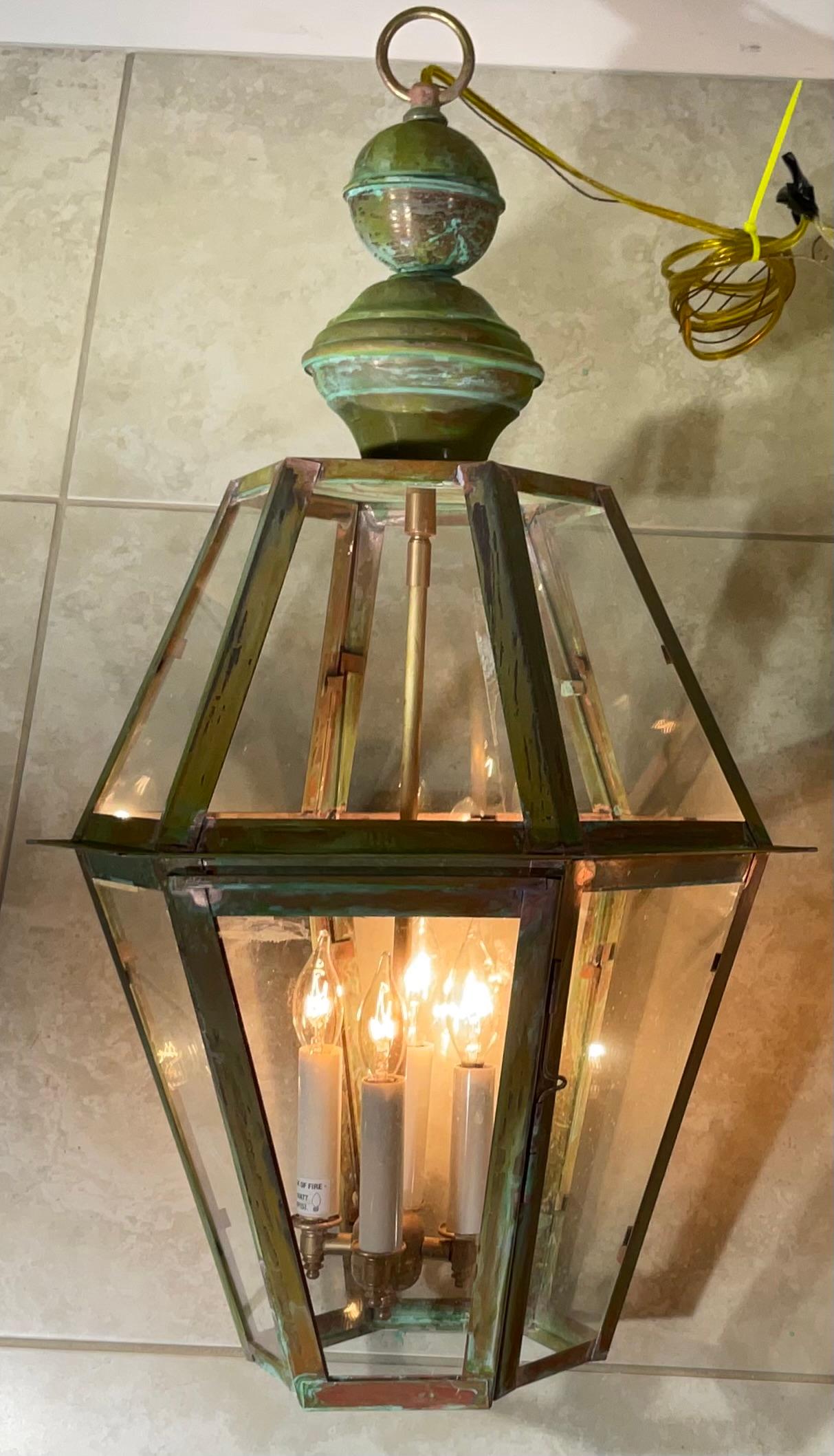 Exceptional six sides pair of hanging lanterns made of handcrafted solid copper and brass stem with four 60/watt lights, beautiful patina ,suitable for wet location
Made in the US ,up to US code , UL approved 
great look indoor or outdoor. 
canopy