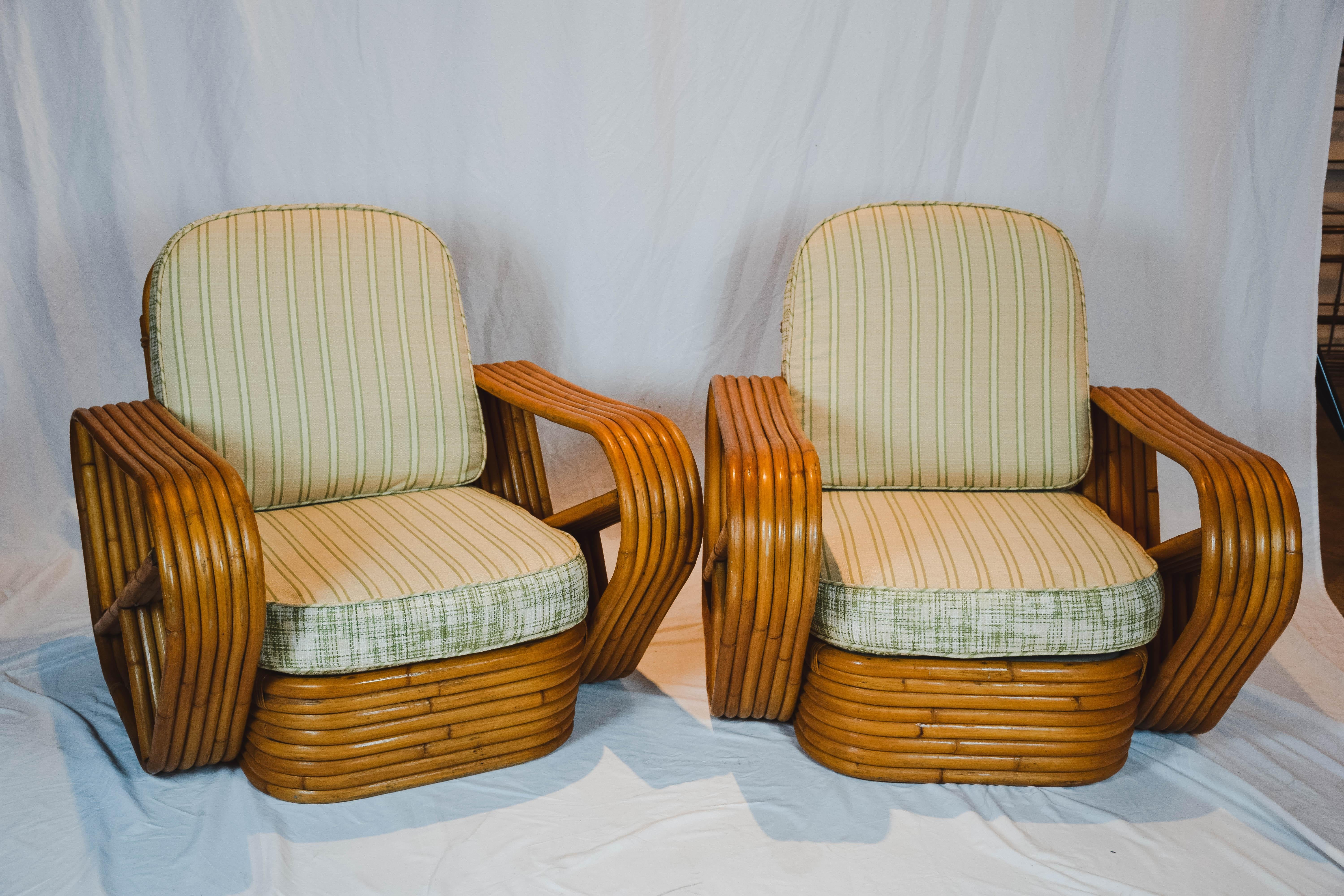 This fabulous pair of Pretzel lounge chairs are attributed to Paul Frankl. Each chair has six strand arms and feature a steam bent rattan frame. The cushions are custom upholstered to be reversible.
