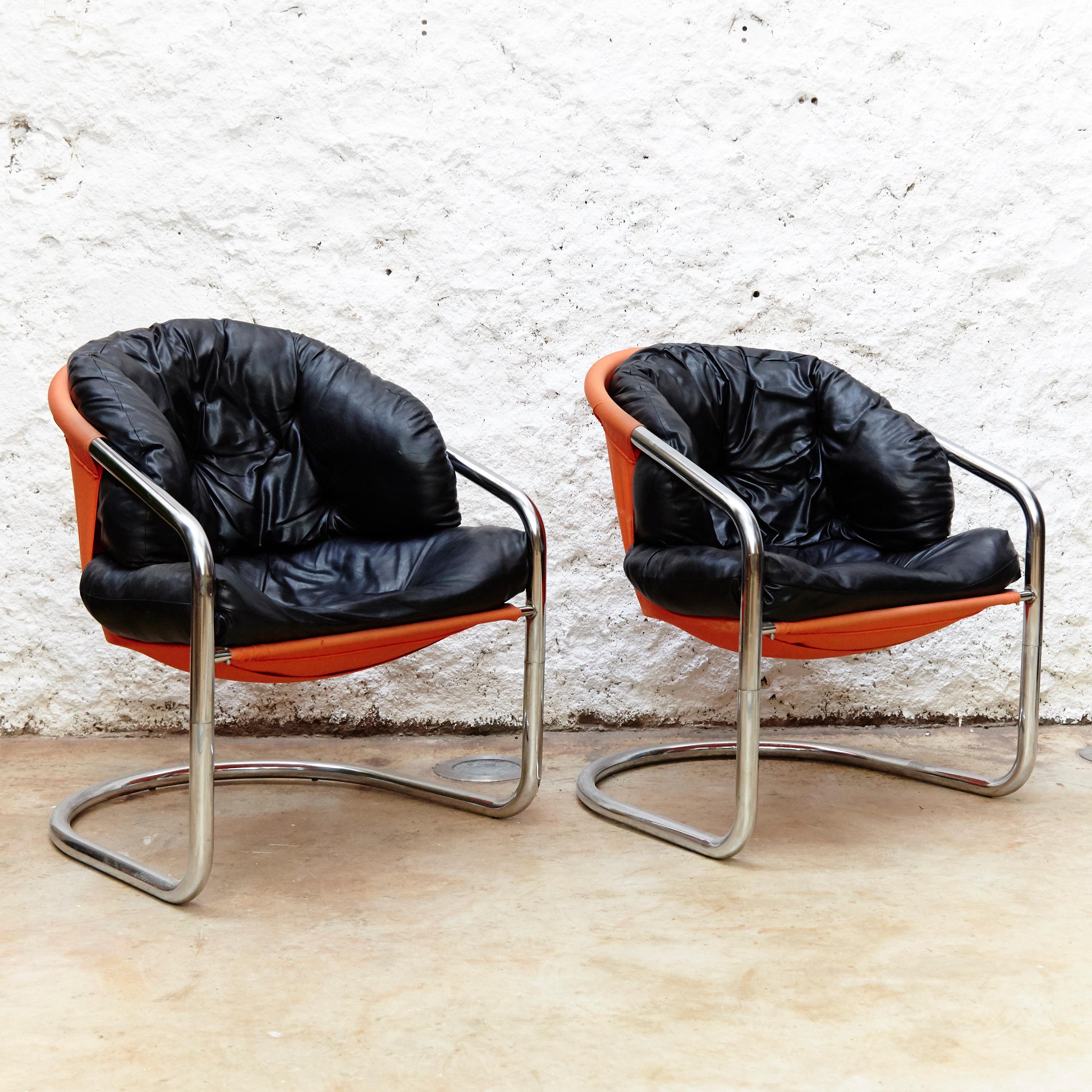 Nice pair of decorative easy chairs by unknown manufacturer.
Combination of Skai and orange fabric with tubular metal frame.
Manufactured in Spain, circa 1970.

In original condition with minor wear consistent of age and use, preserving a